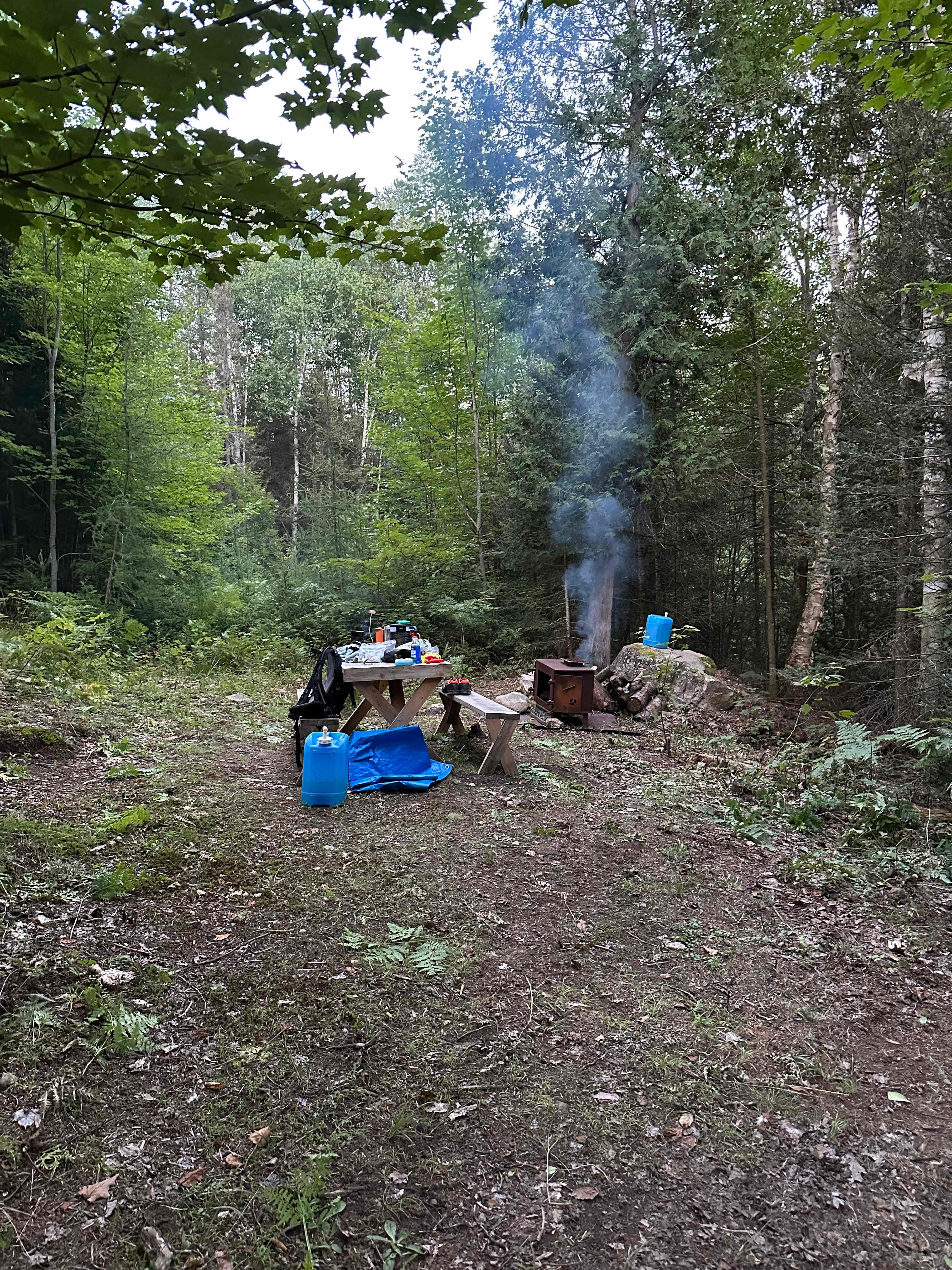 Setting up for dinner, fireplace, picnic table, drinking water and washing