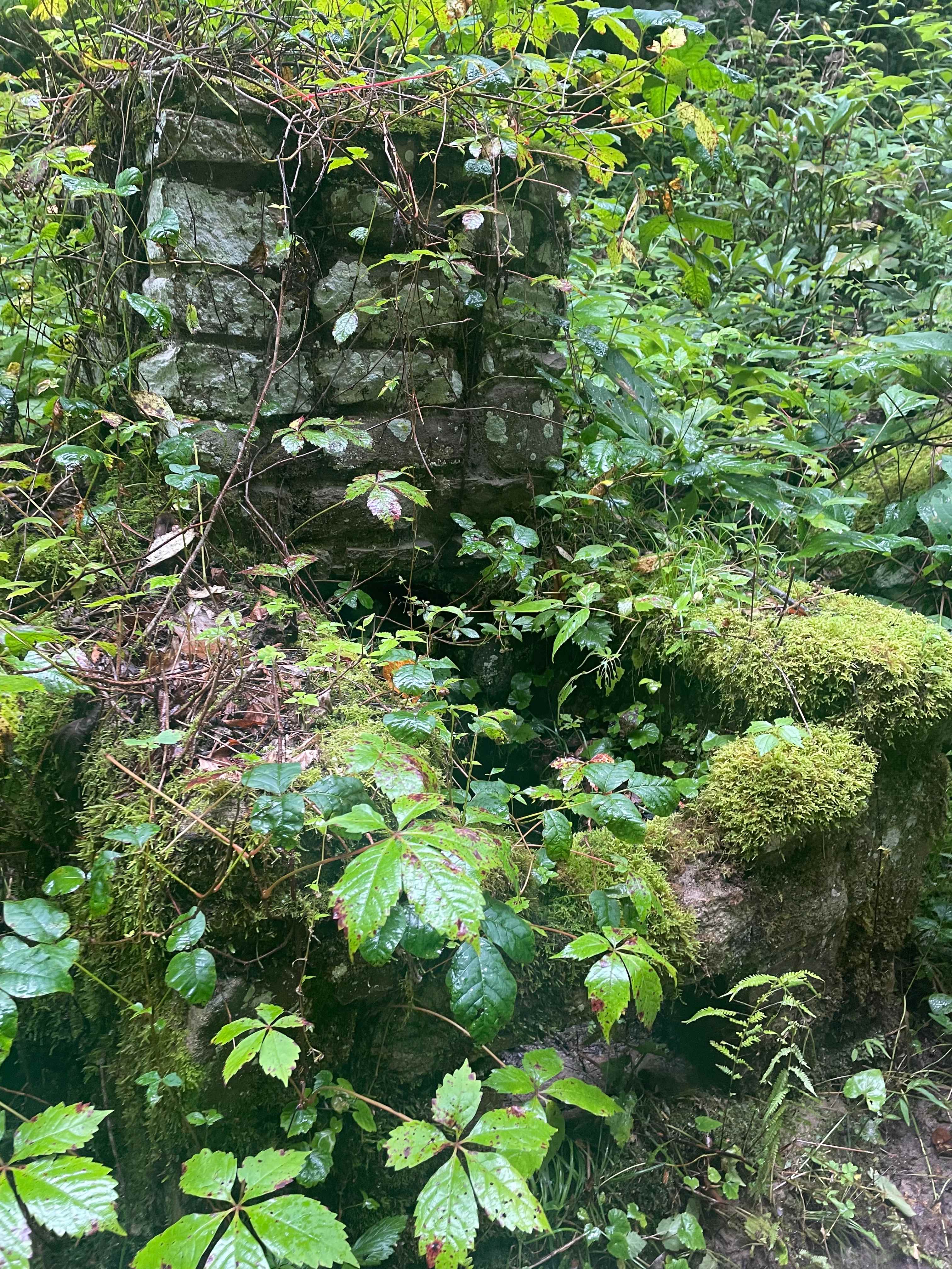 Old stone building built into a rock wall