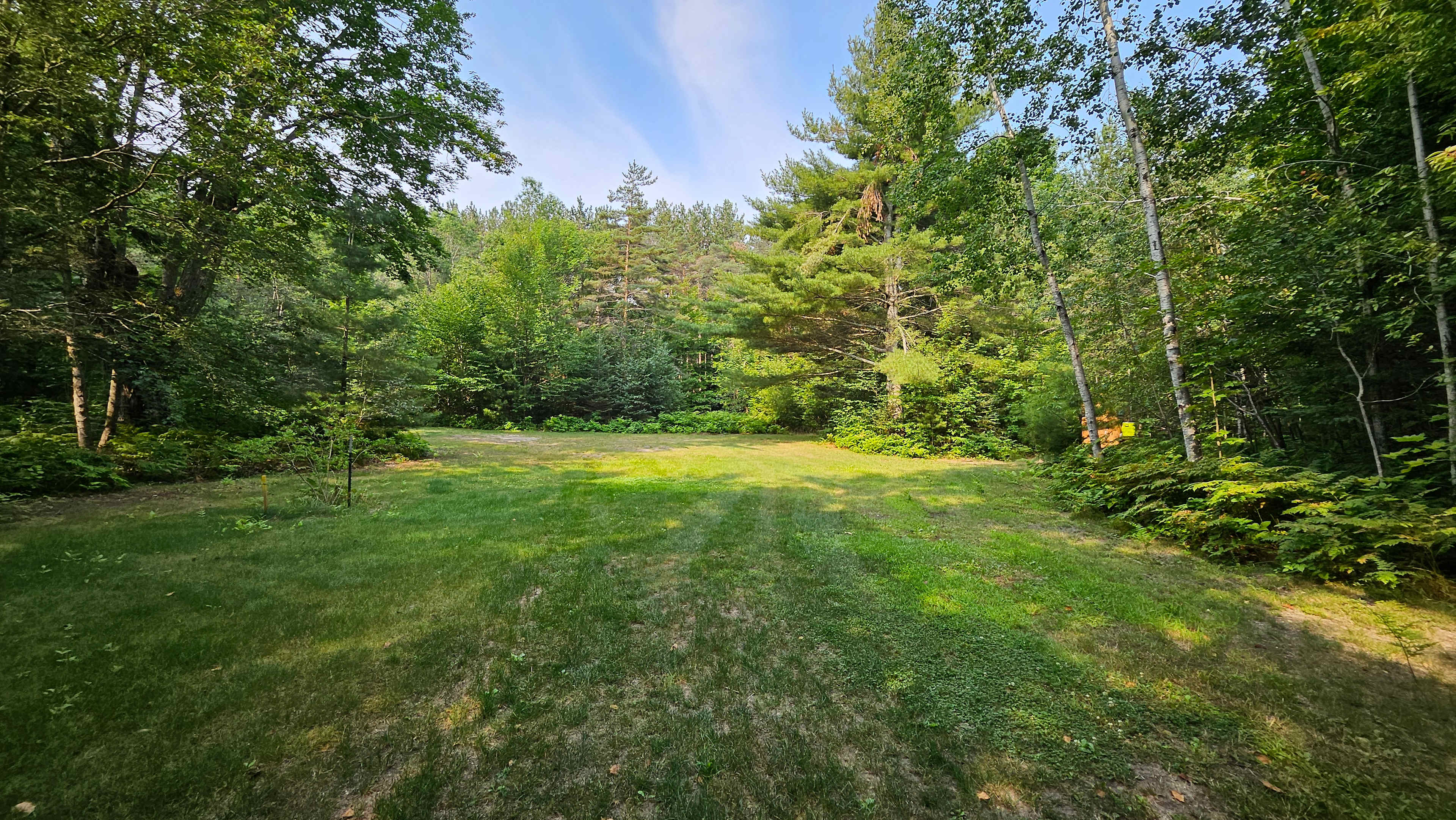 View turning into camp, privy to right, then the land opens up to the left for even more room.