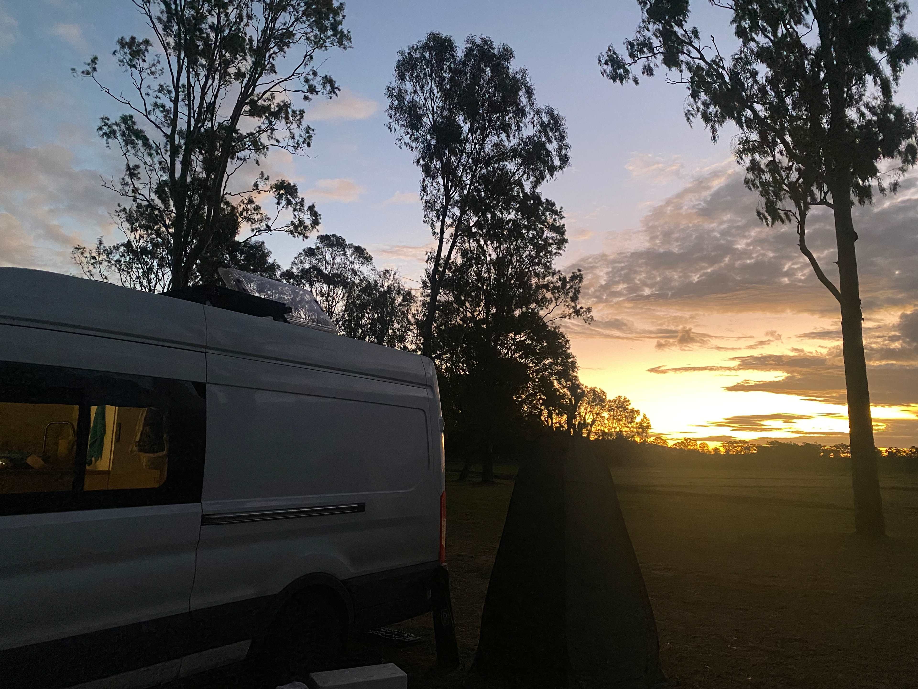 Last of the sun over the field & van