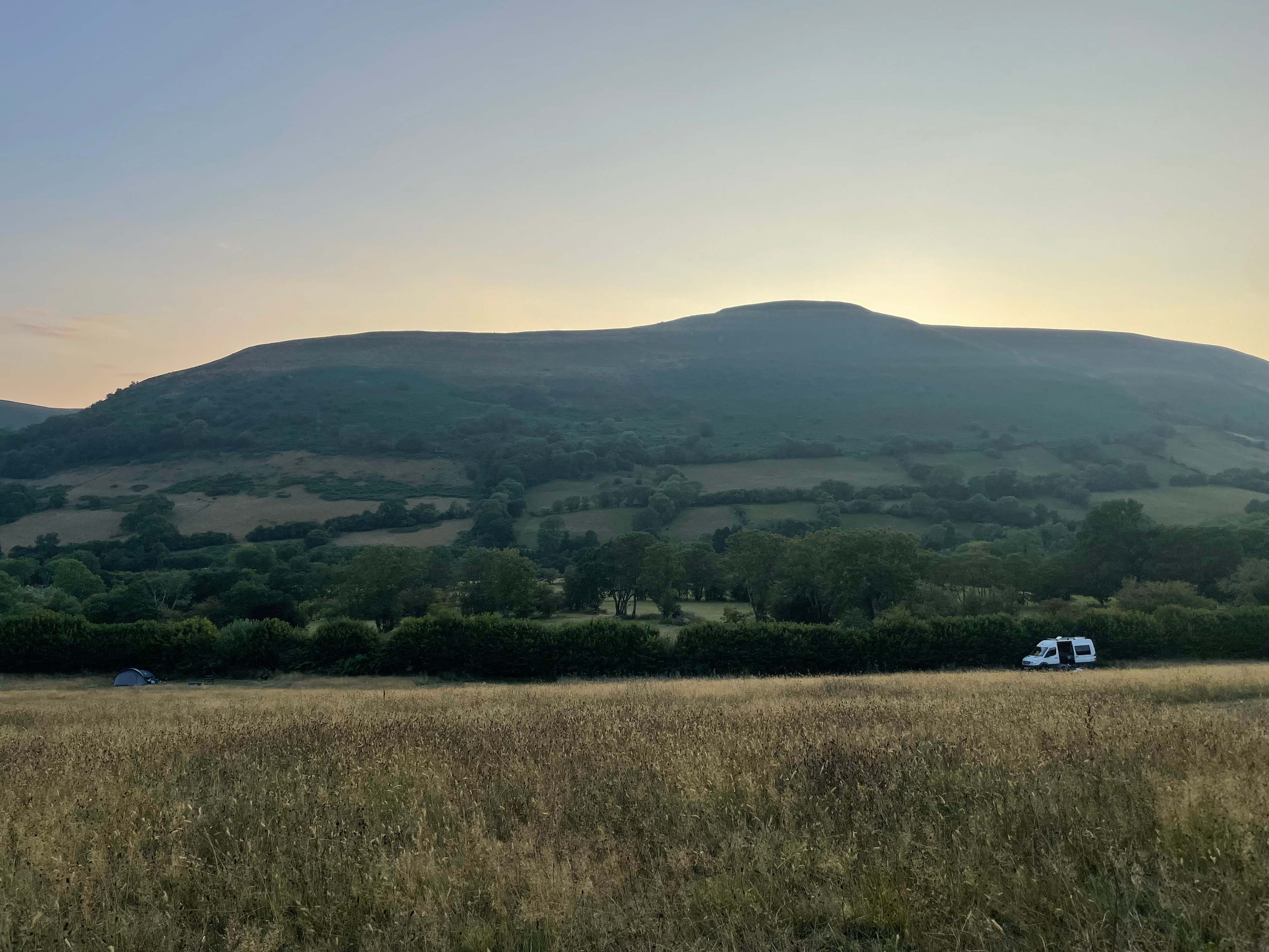 Watching the sun sink behind the hill. 