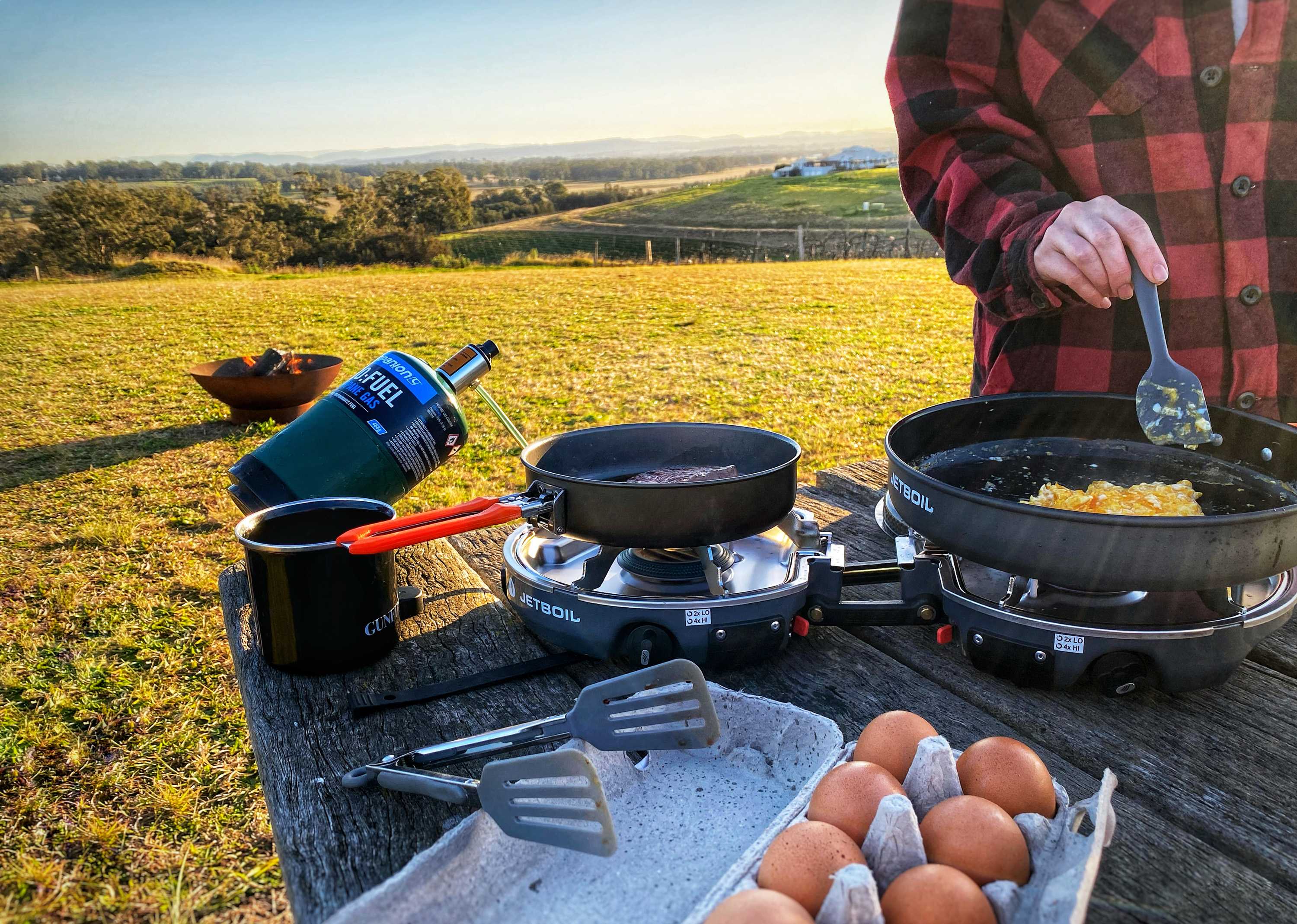 a beautiful morning by the fire and breakfast made easy with a picnic bench at camp. no need to set up the table.