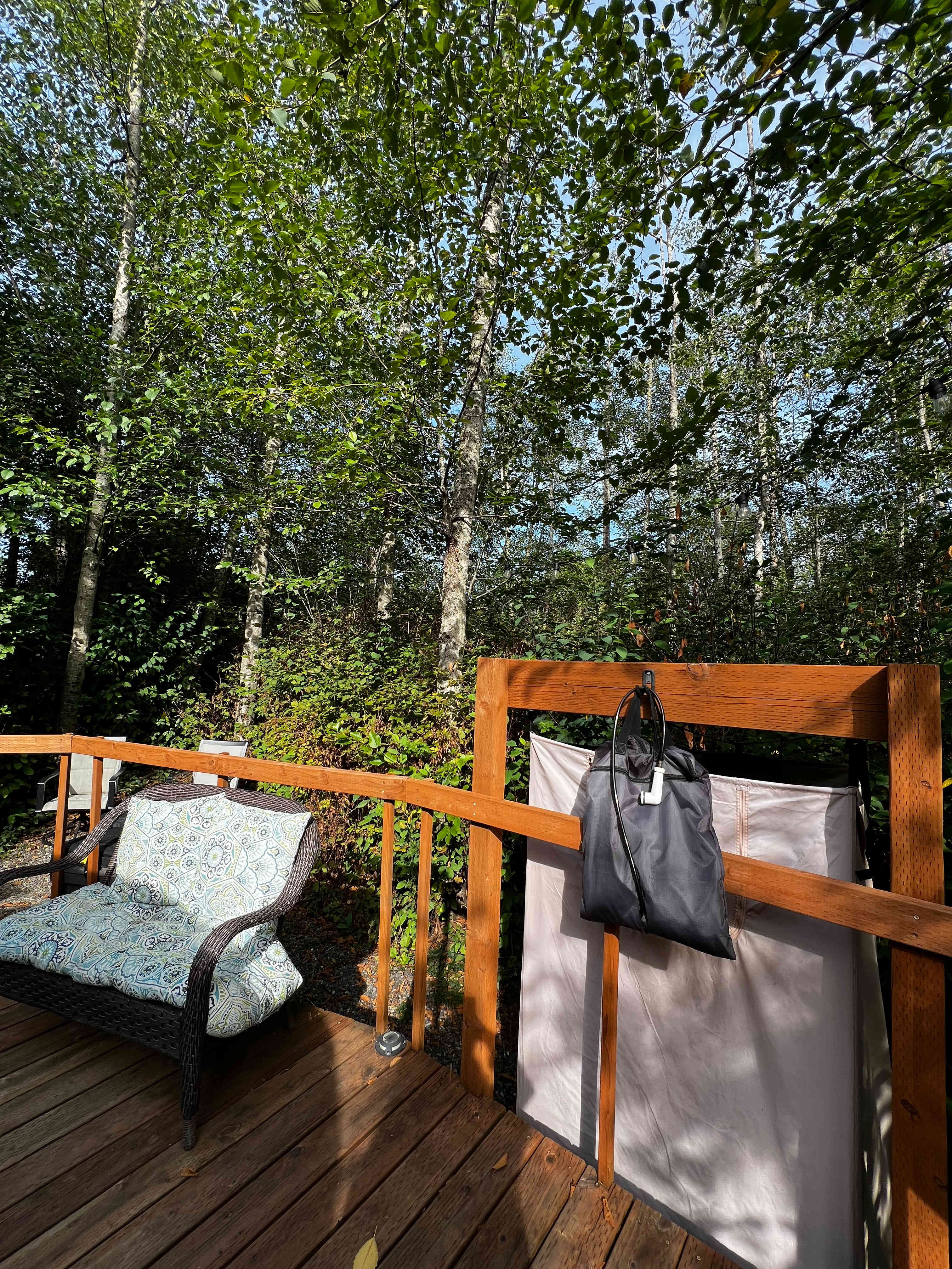 Outdoor seating next to solar shower area 