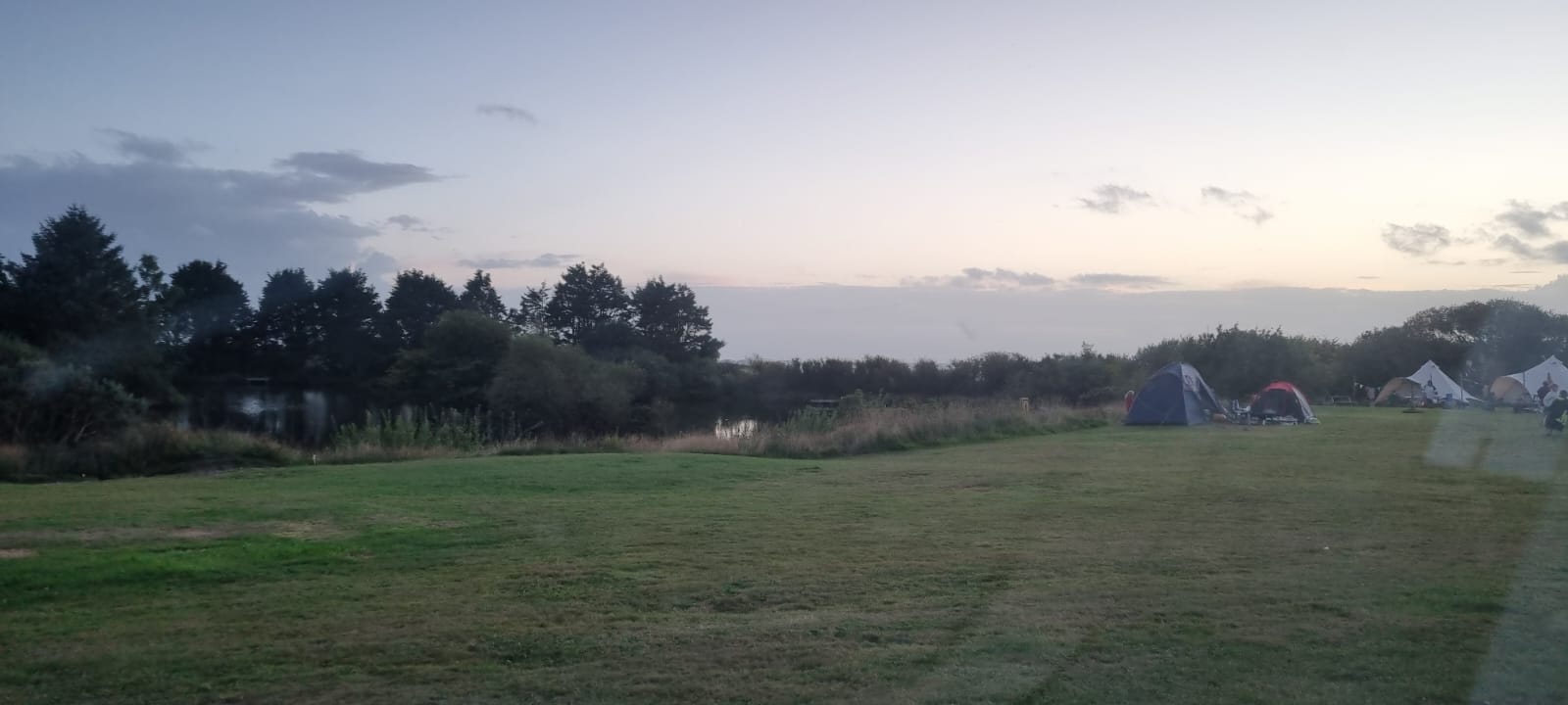 View across camping ground to fishing lake