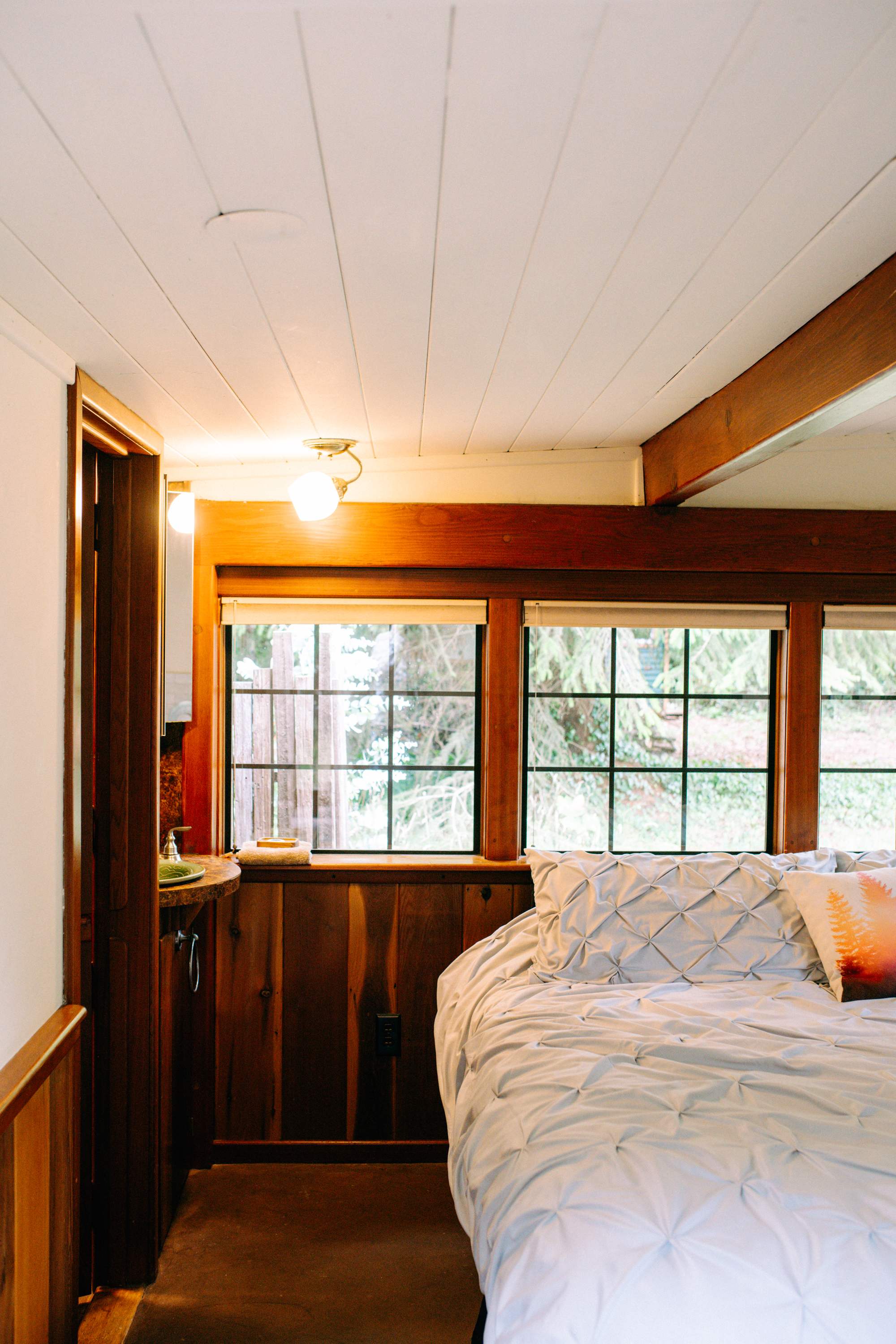 The bathroom is just to the left of the bed.