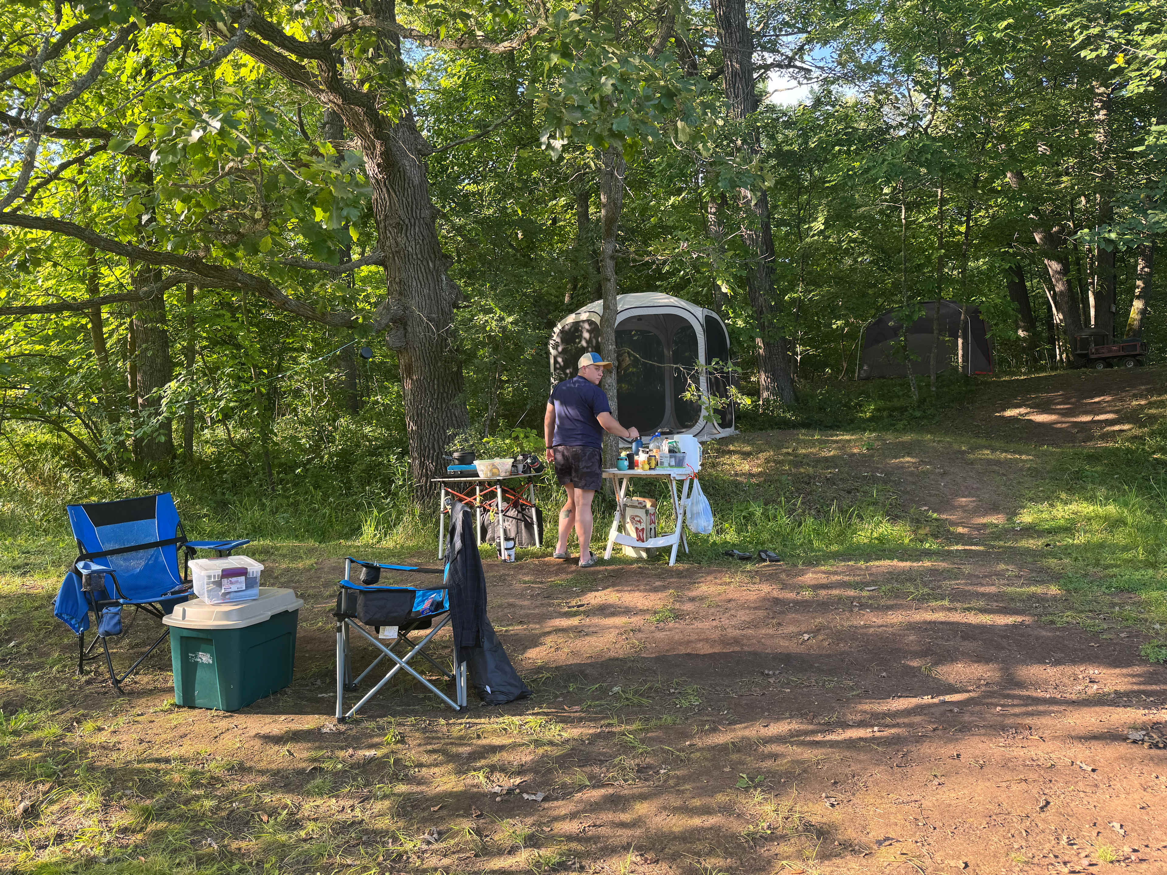 View from next to fire pit. Set up screened in shelter and tent on tier above