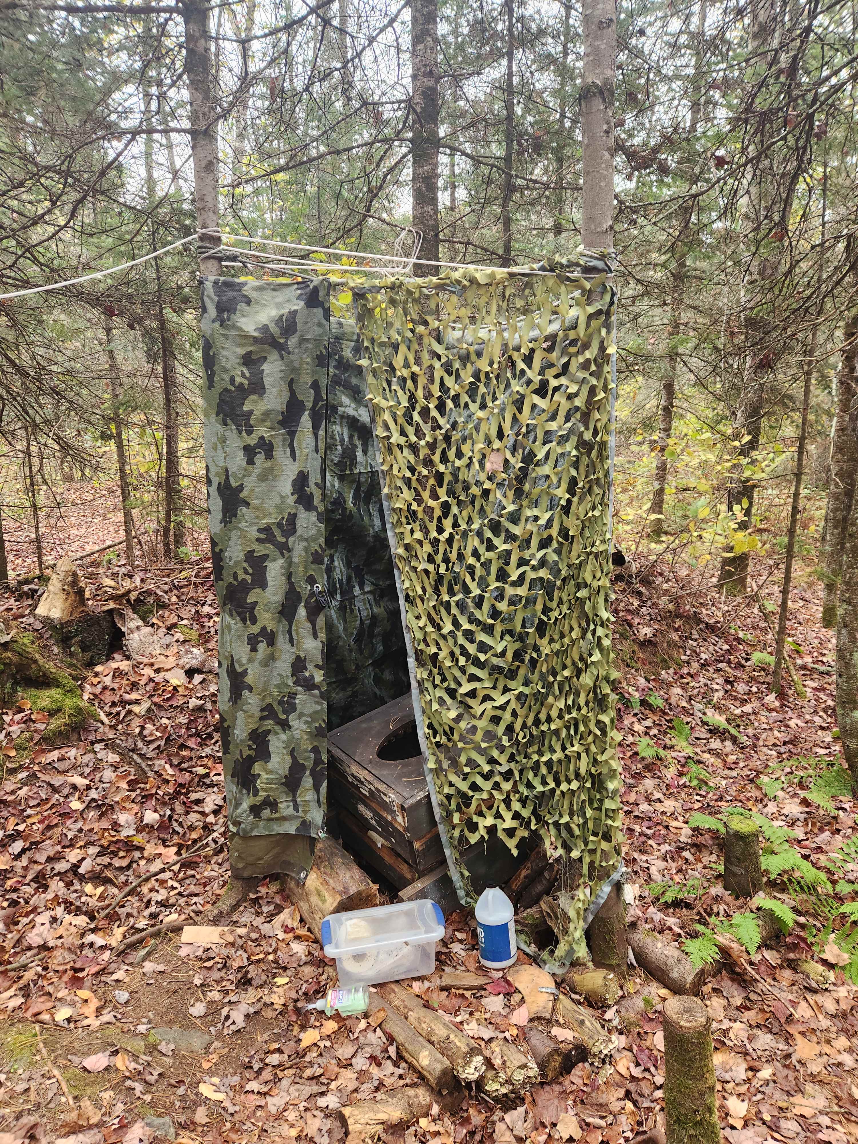 Provided vault/pit toilet with hand sanitizer and toilet paper