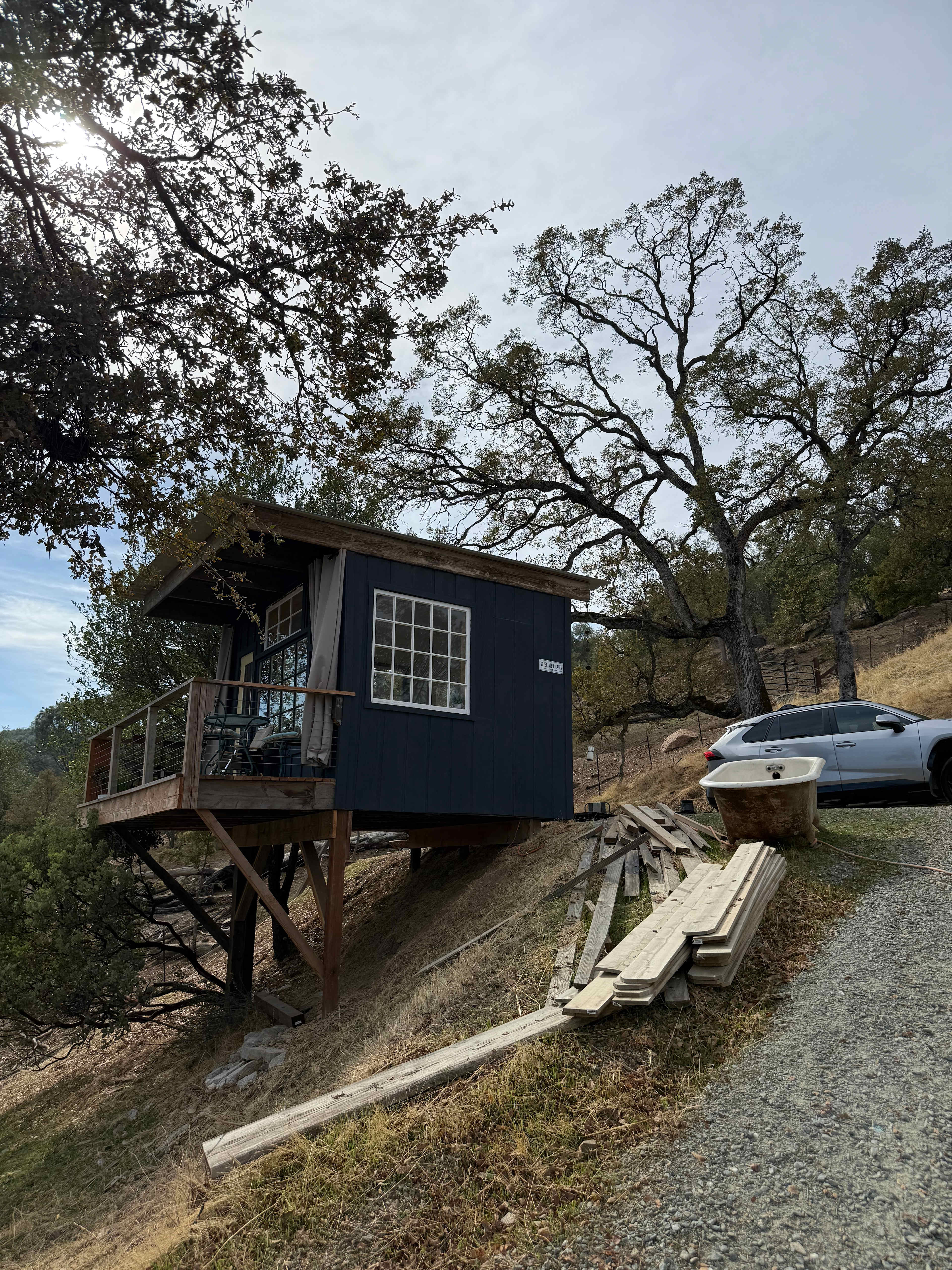 View from bottom of slope where the outdoor kitchen and coop are