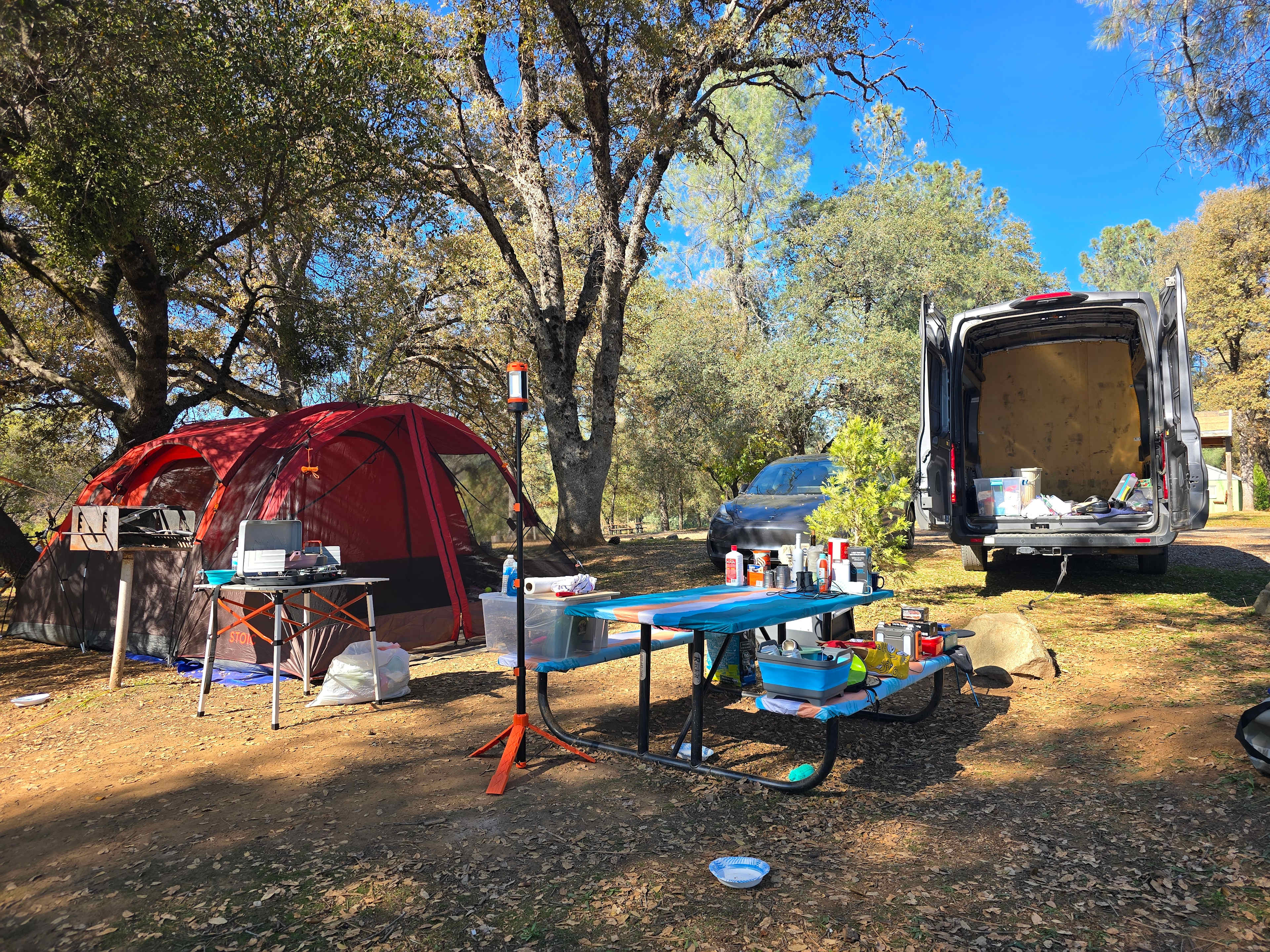 The van is facing out. The tent is set up on the flat spot.