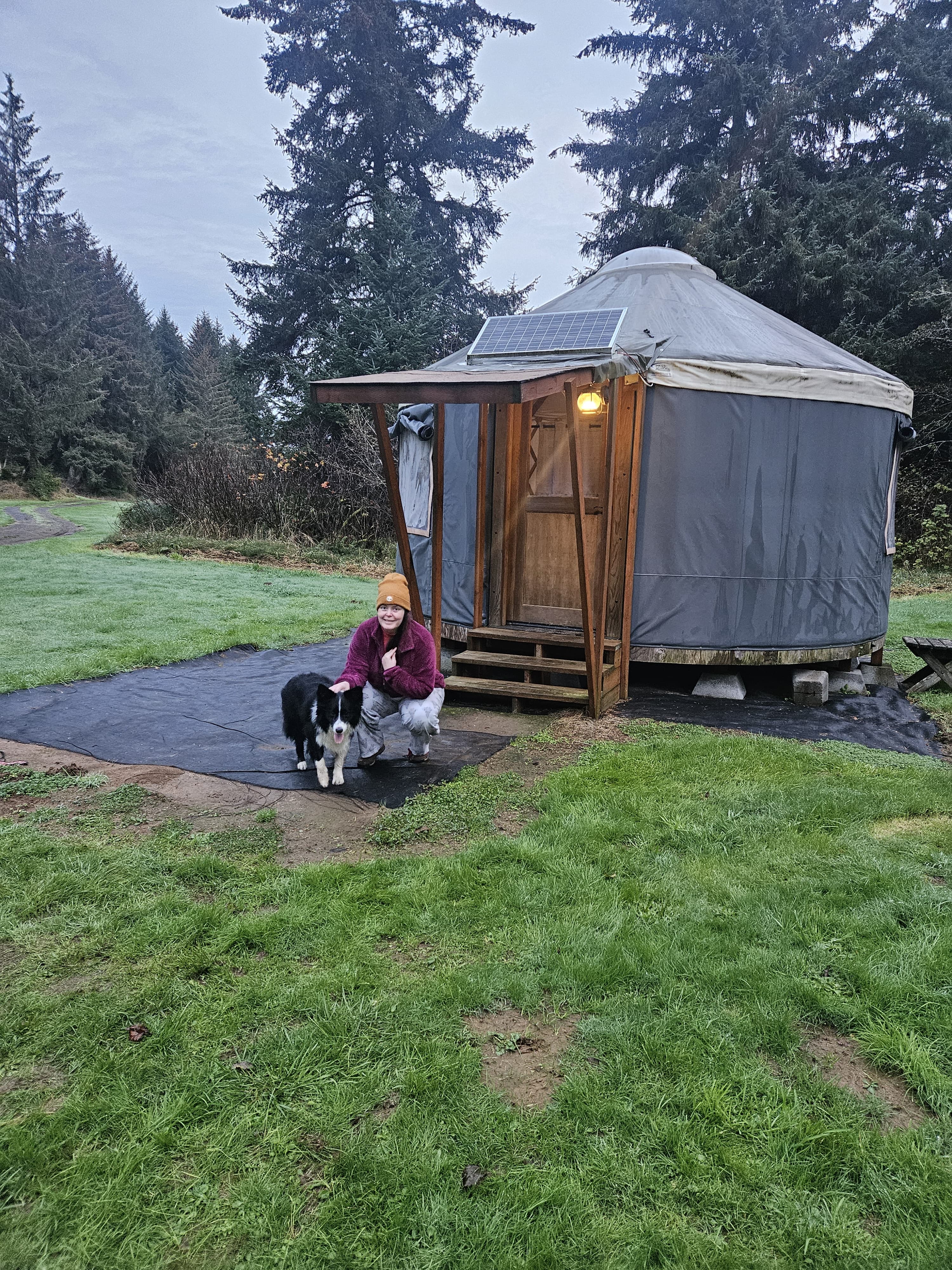 Outside the yurt with our border collie.