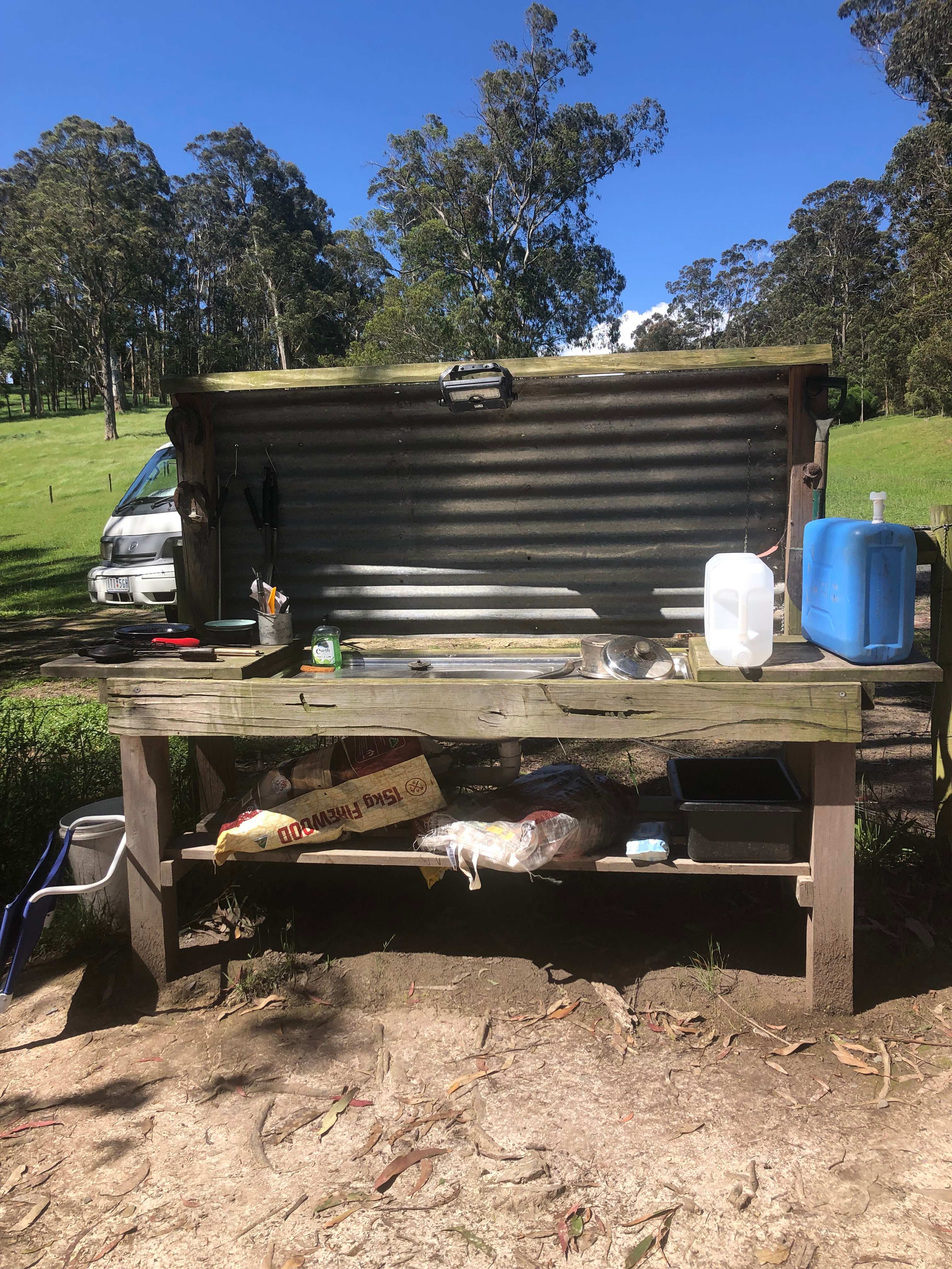 Mud kitchen with containers of potable water
