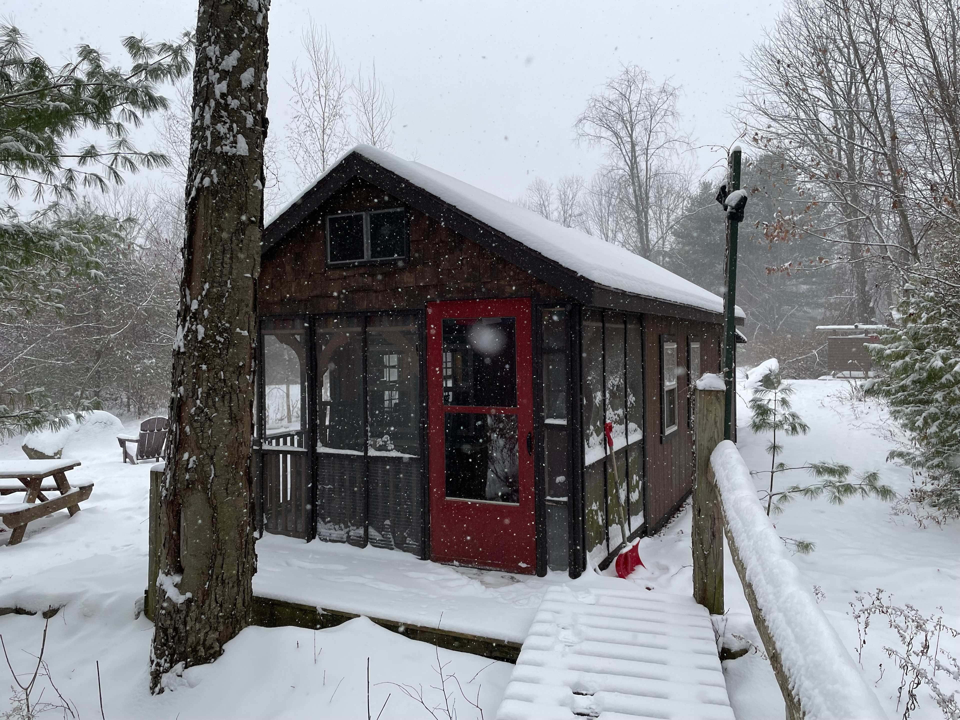The cabin during the day, while snowing