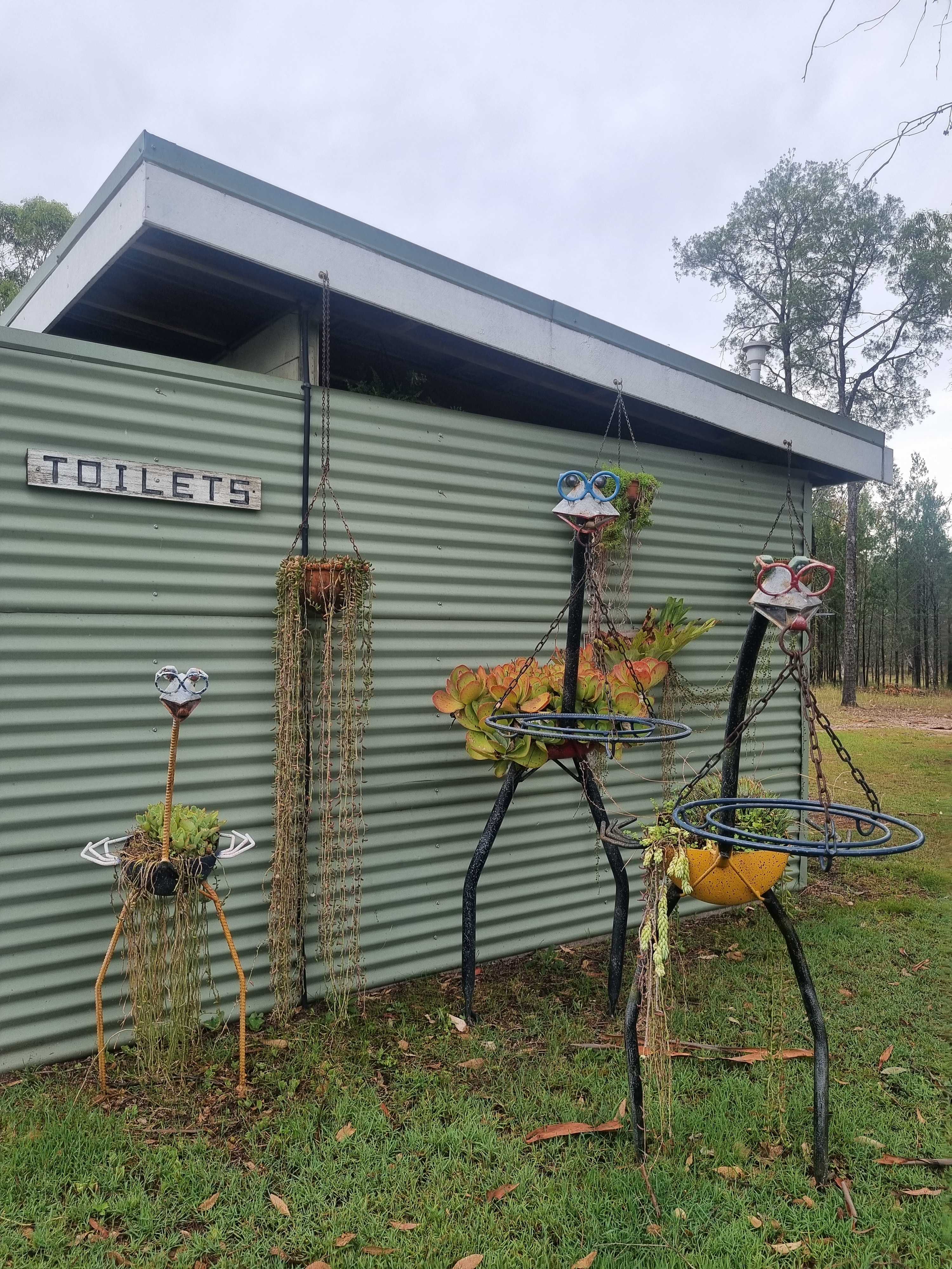 Separate toilet and showrr blocks right next to each other with seats outside