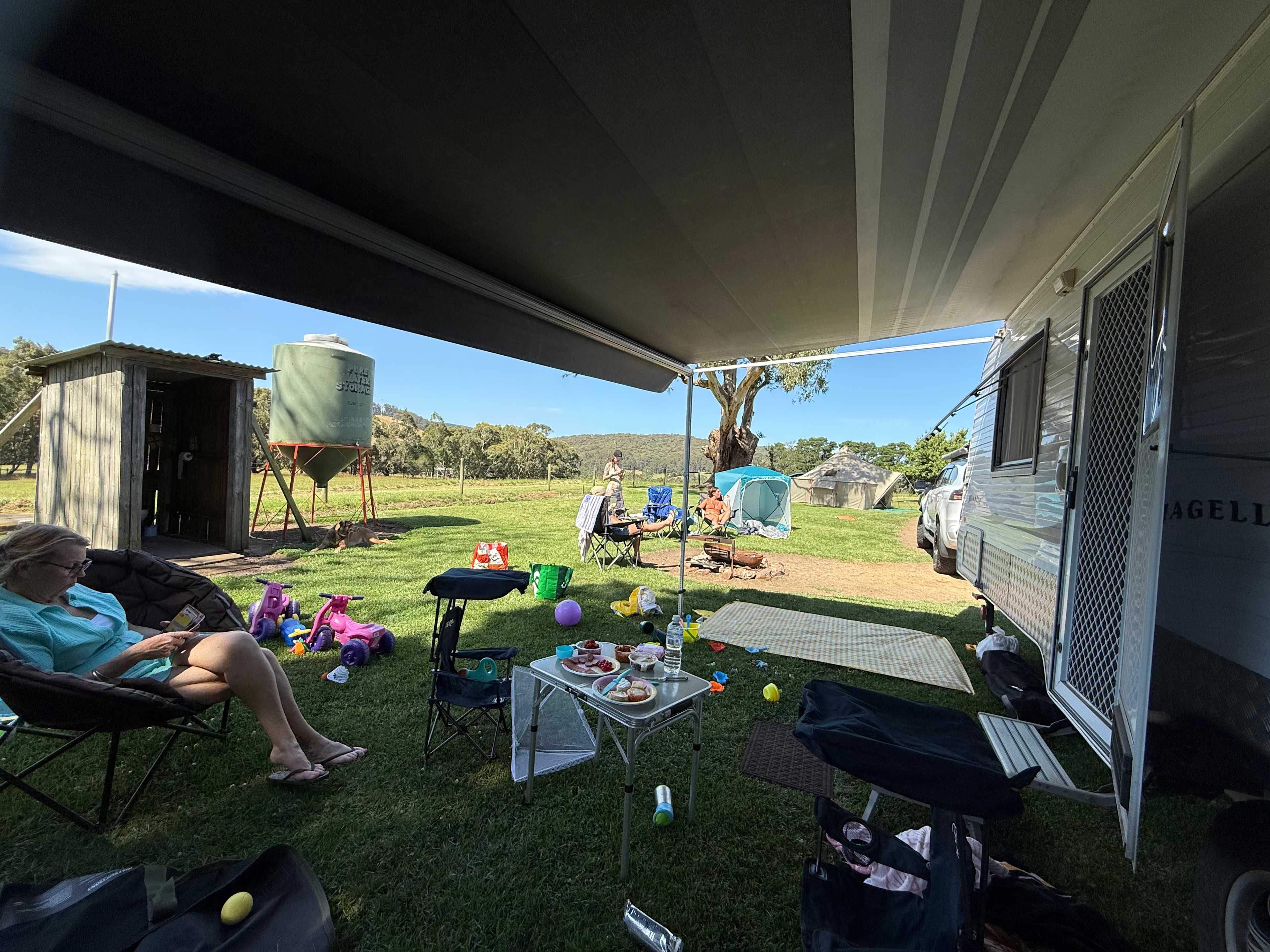 Under the caravan awning and view of the toilet.