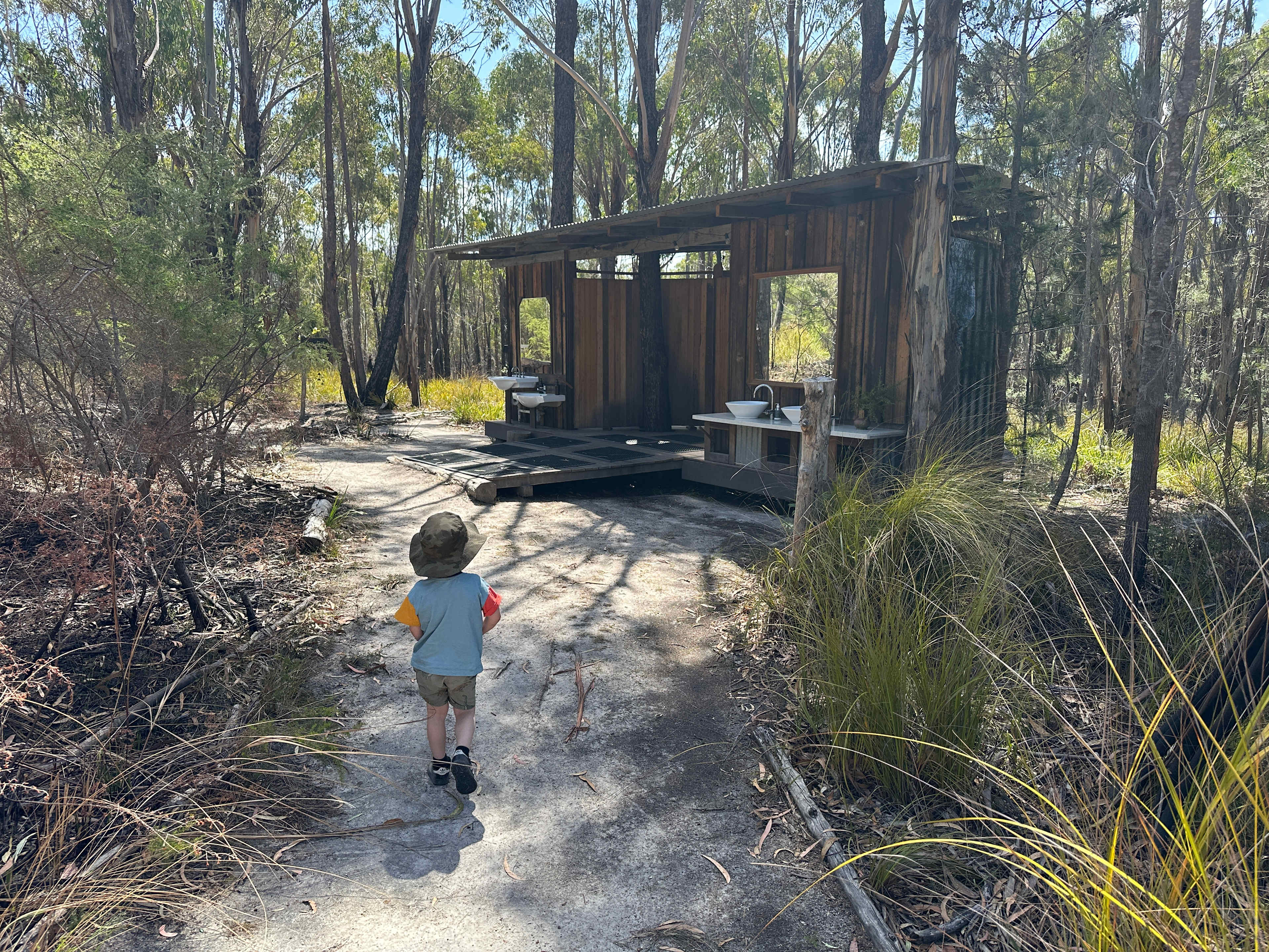 Warm, outdoor showers immersed in bush.