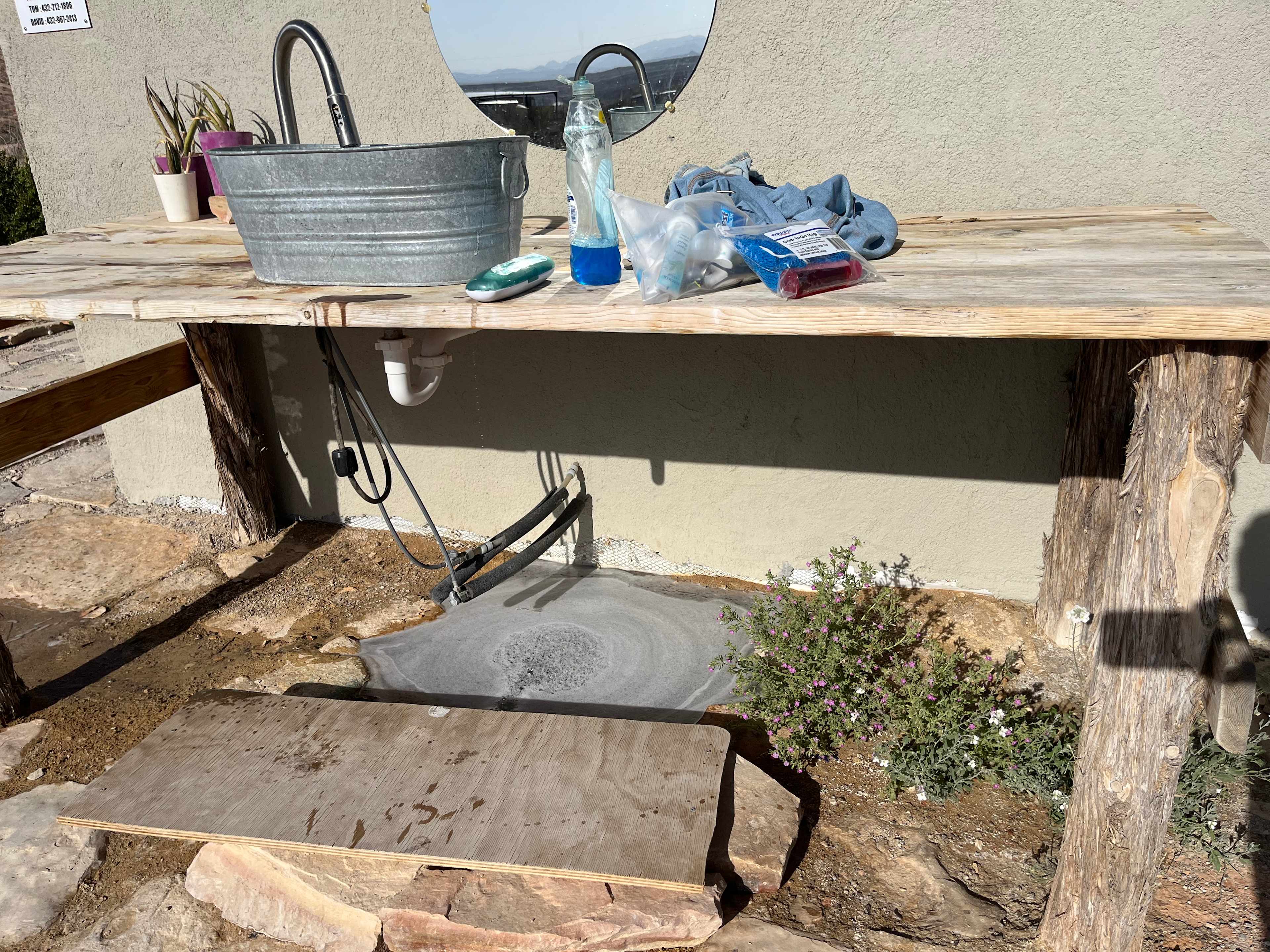 Hot water sink at the edge of the shower house 