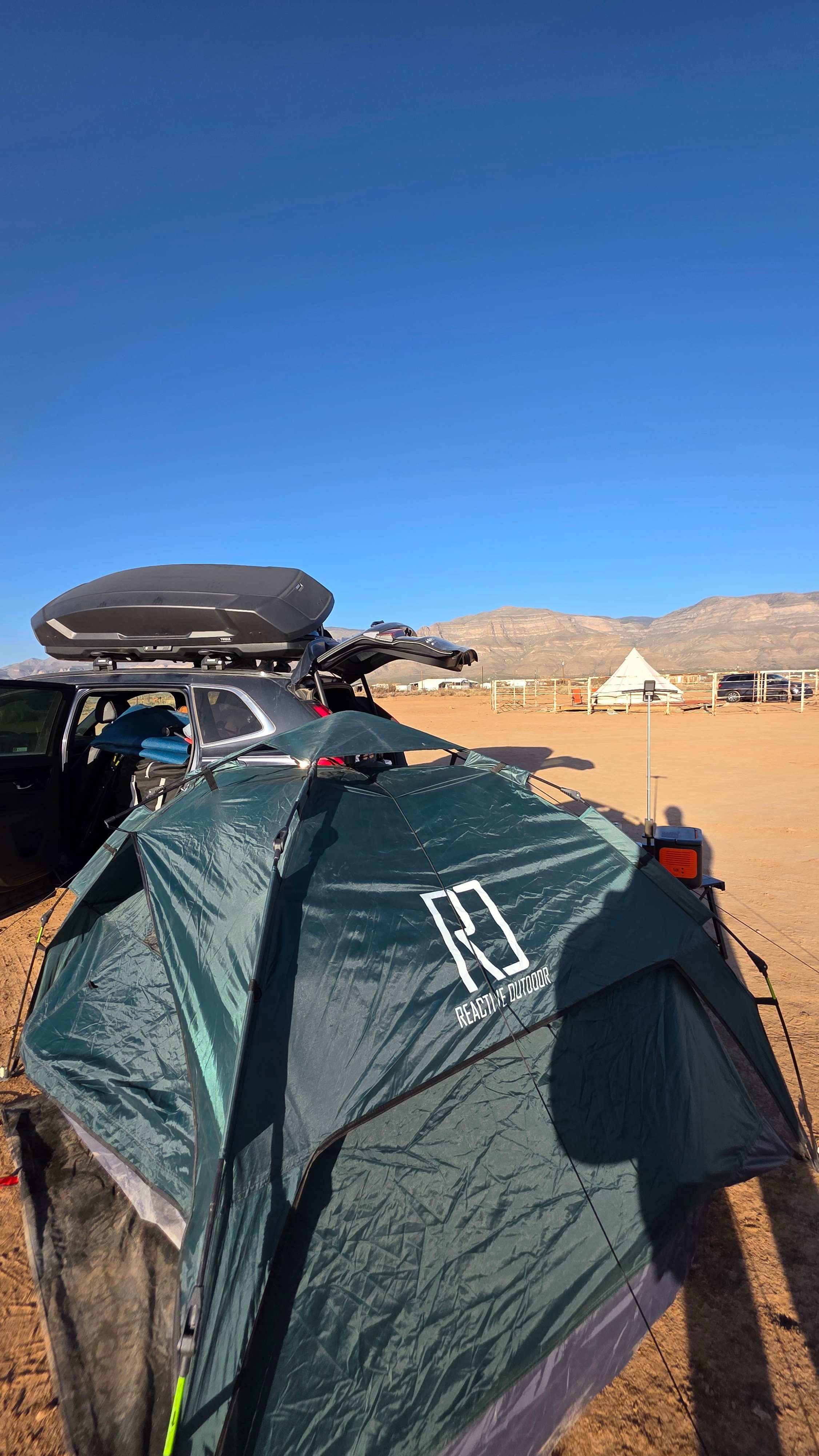 Tent on site near yurt and bathroom yurt.