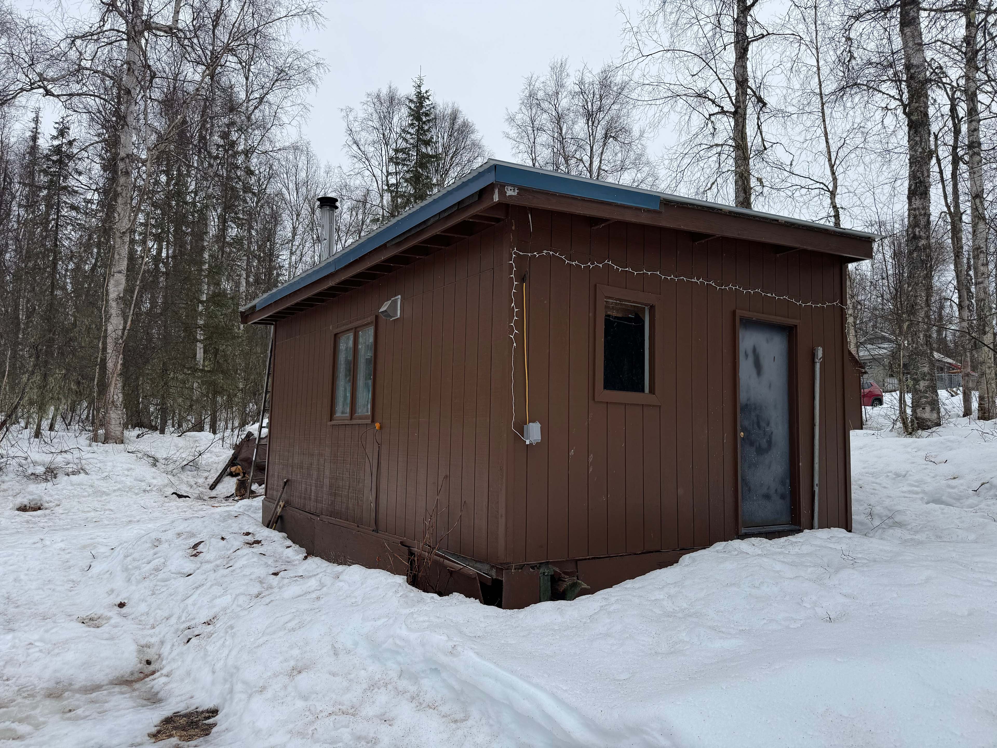 True Alaska dry cabin: electricity and heat by wood stove.