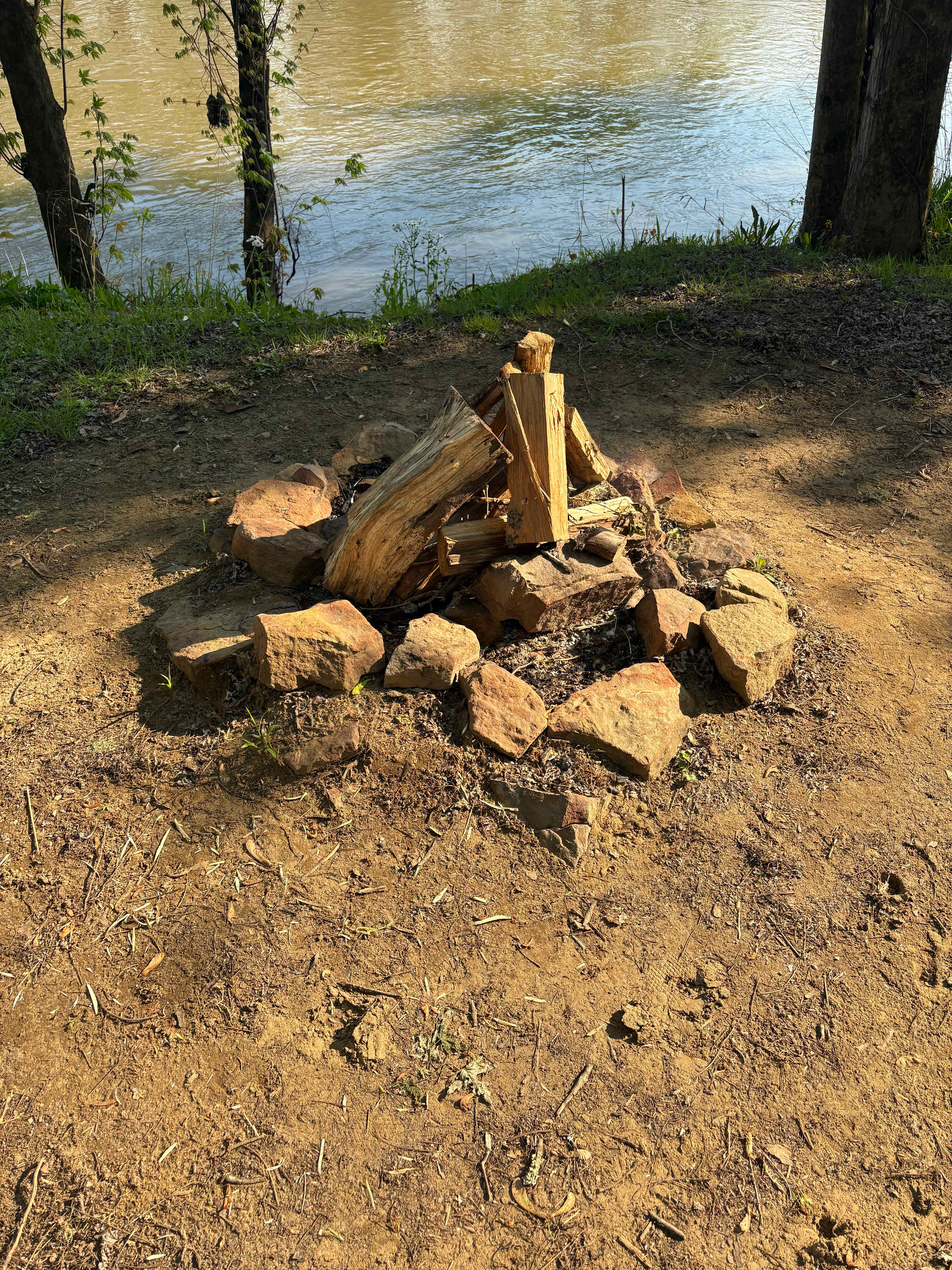 Fire pit at camp on waters edge.  