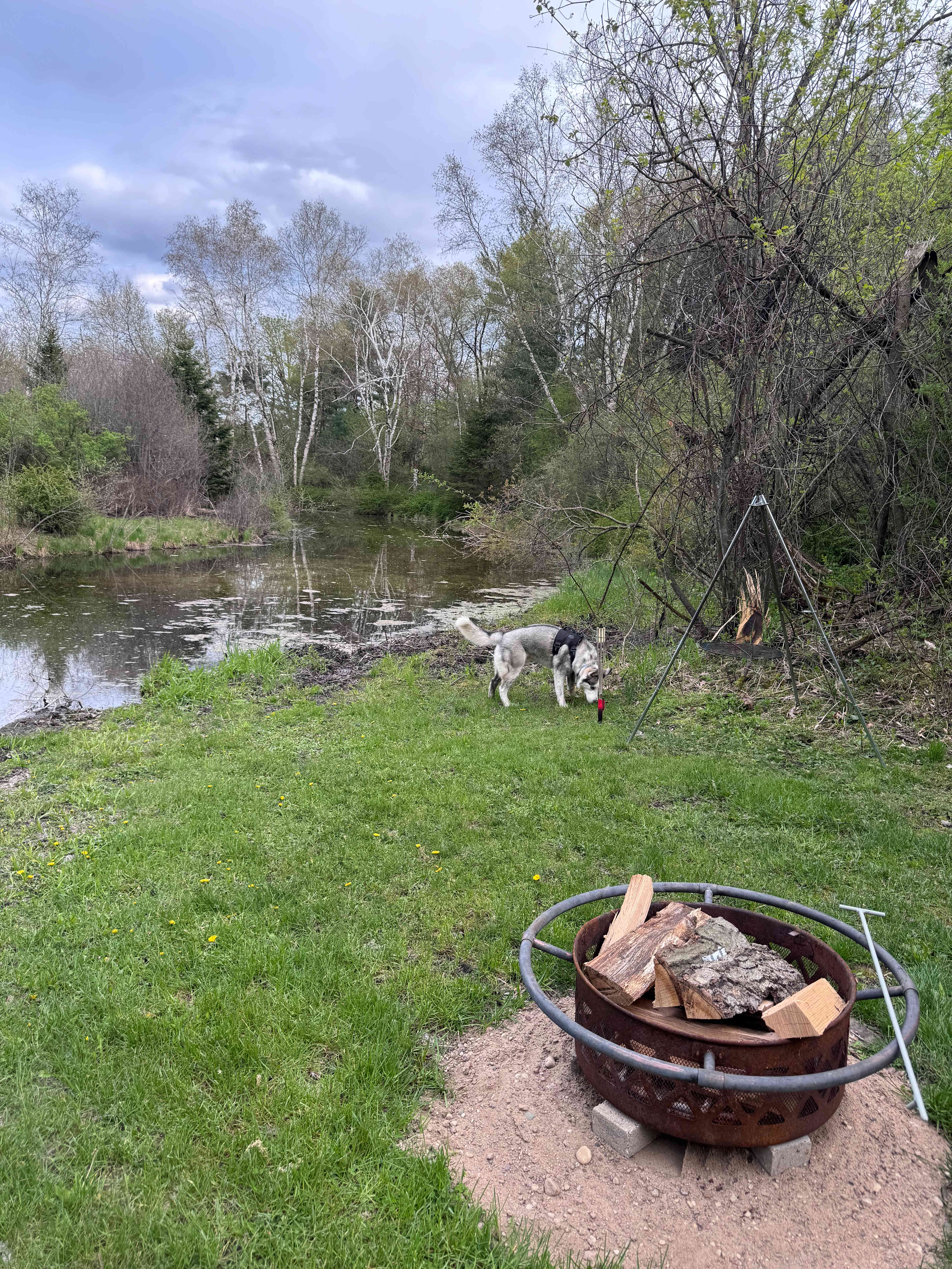 Water side, with fire ring, poker stick, grilling grate, and on site water travel