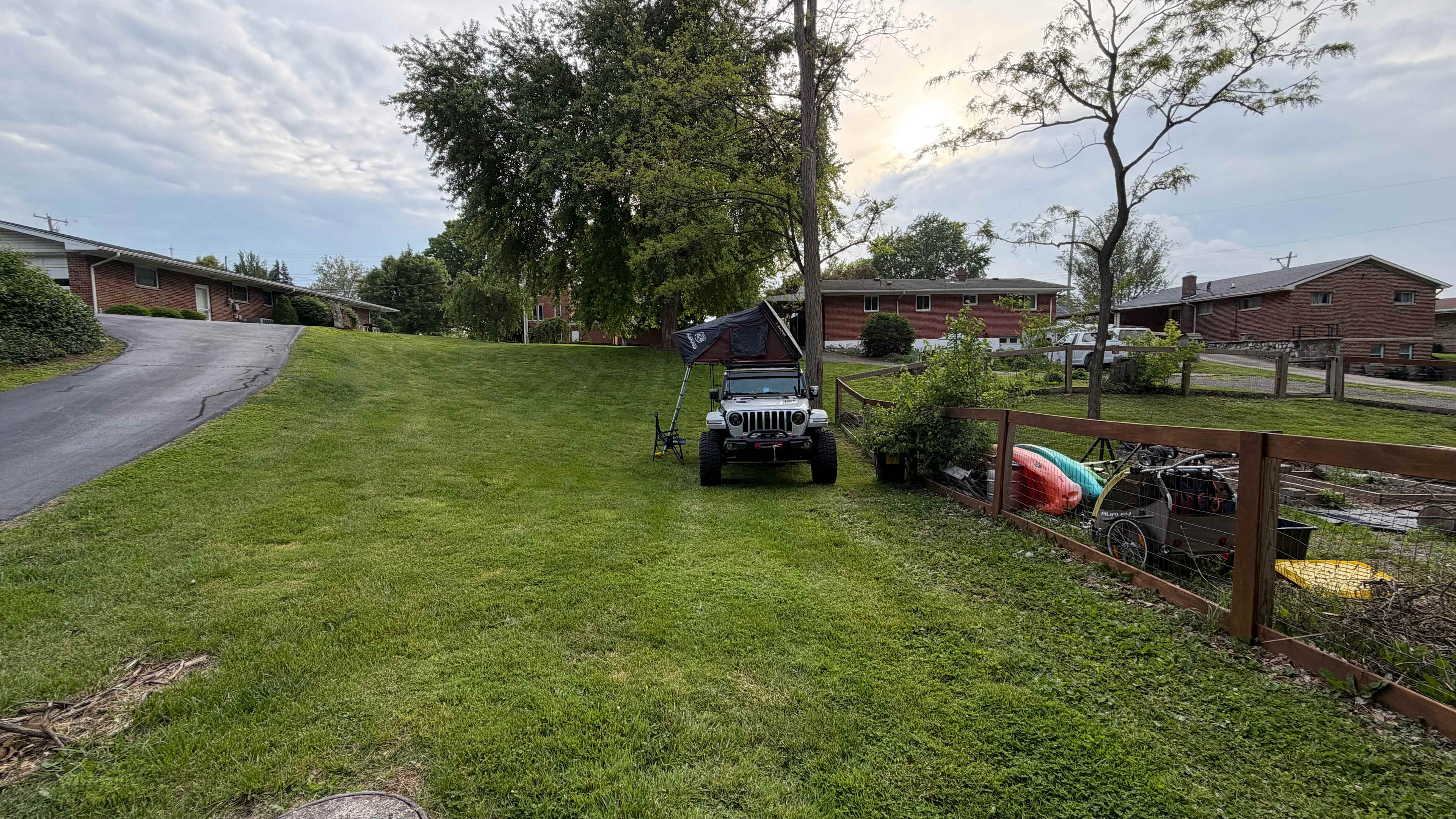 The property is from the fence on the right to the driveway. The back of the property is fairly level, but inclines quite a bit towards the front.