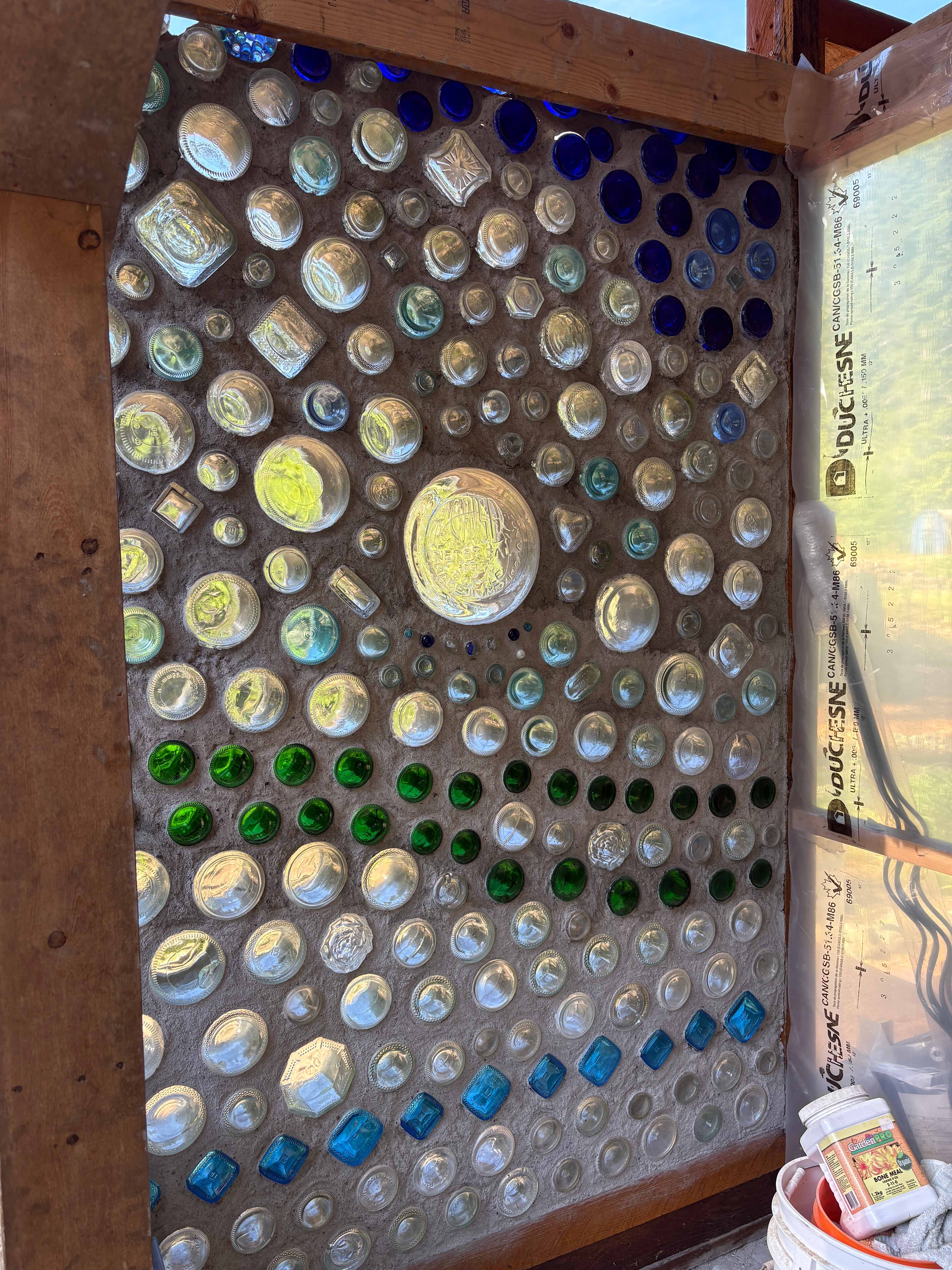 No end to projects on the Doig’s land! Some are structural and some are artistic. And some are a combo of both. Like this wall of glass Susan has been working on. 