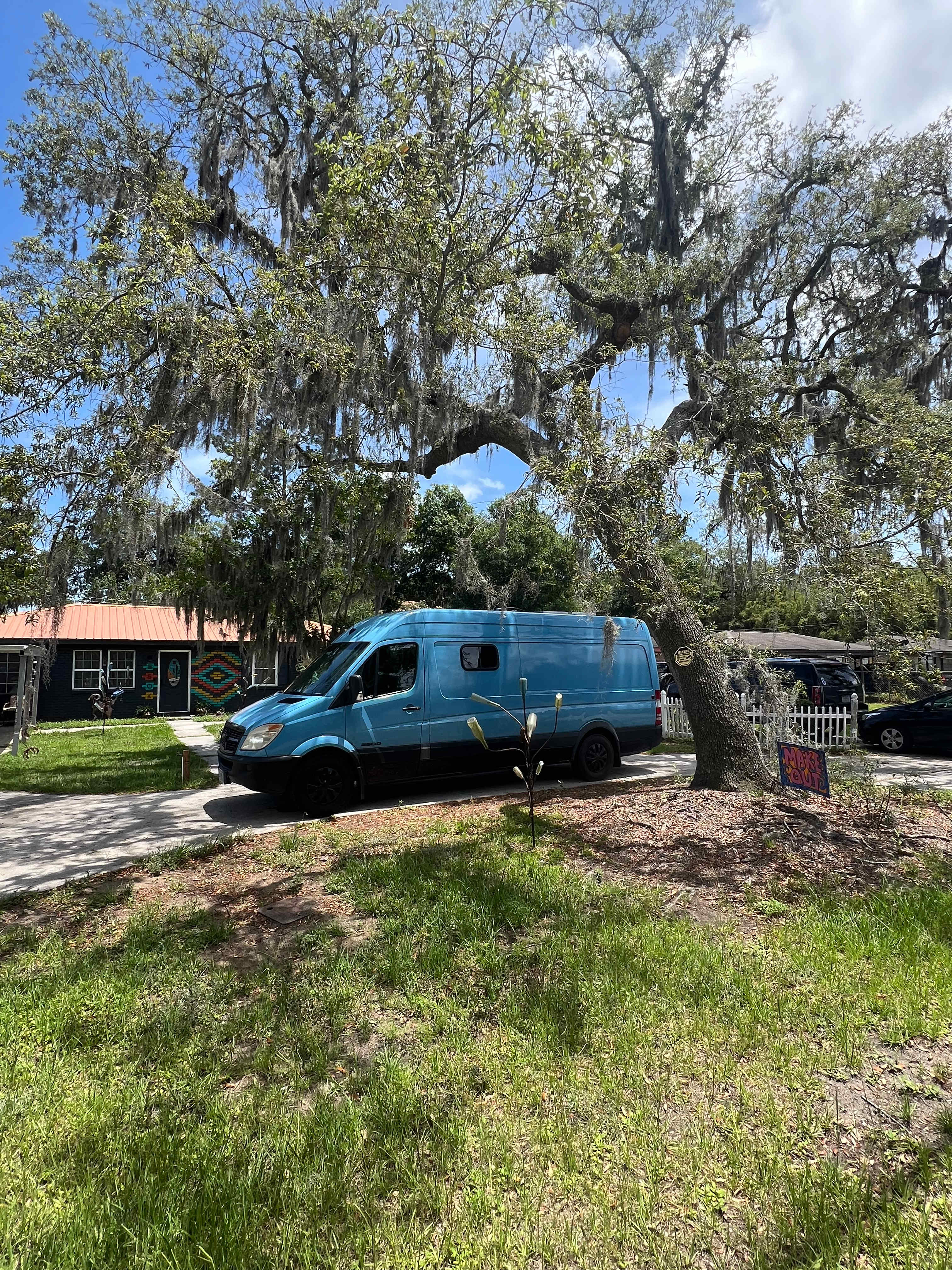 The parking spot is on the circular driveway at the front of the lawn.