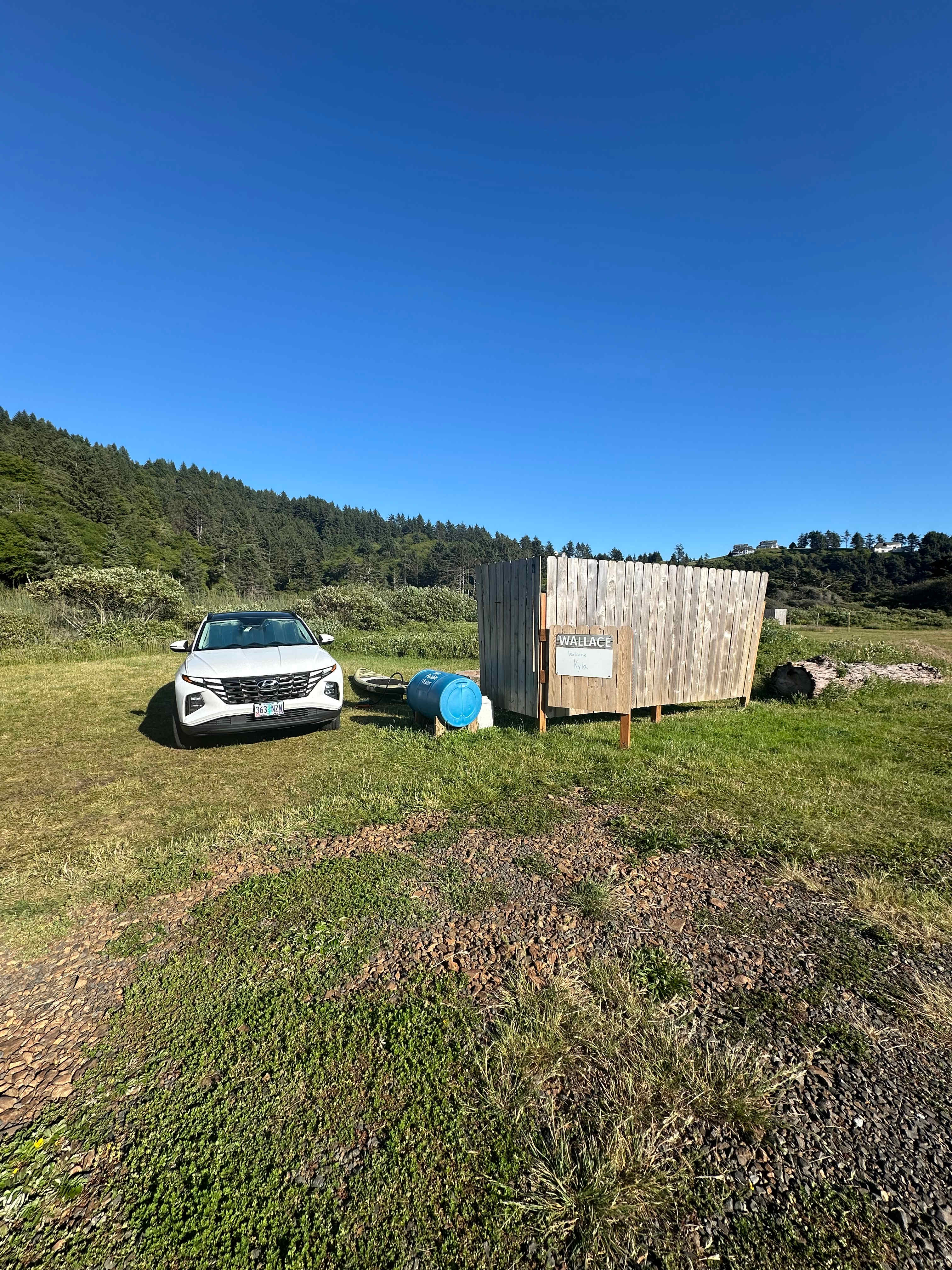 The Wallace site, like the others, has a partial privacy fence that also serves as a wind break. Water is in the blue tanks for general rinsing needs, though it is not potable. 