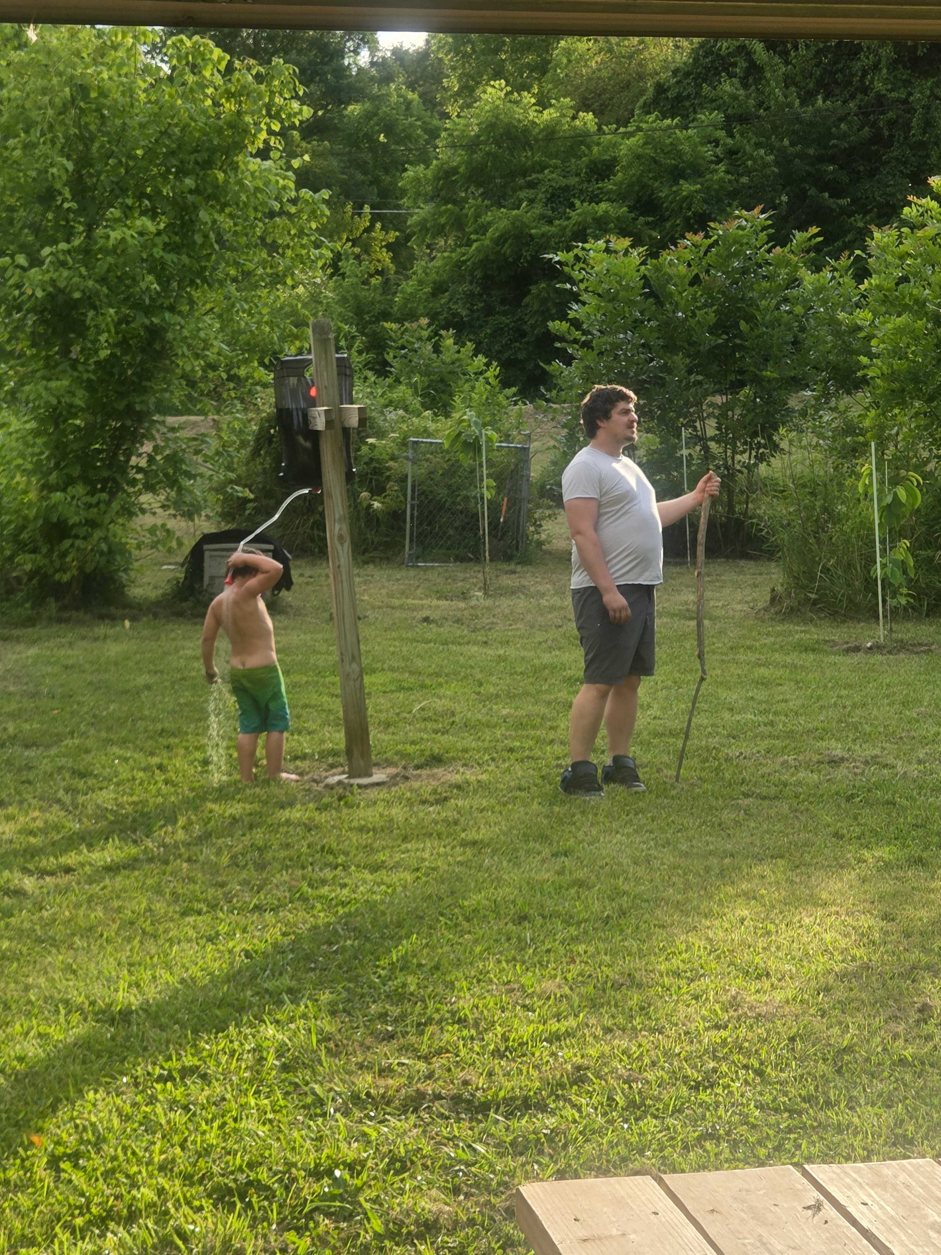 My son using the little "portable shower" they have haha