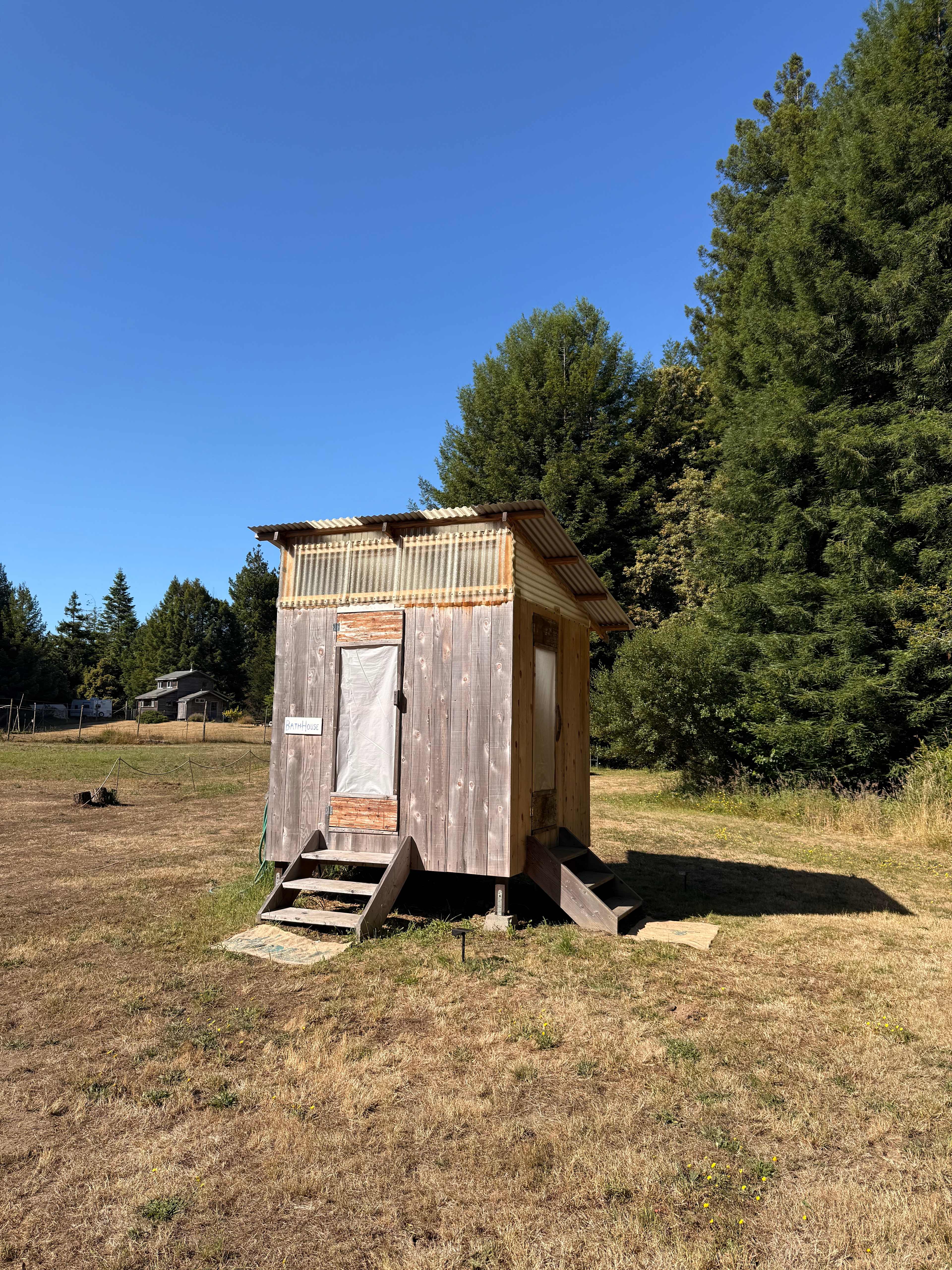 Bath house with shower and composting toilet