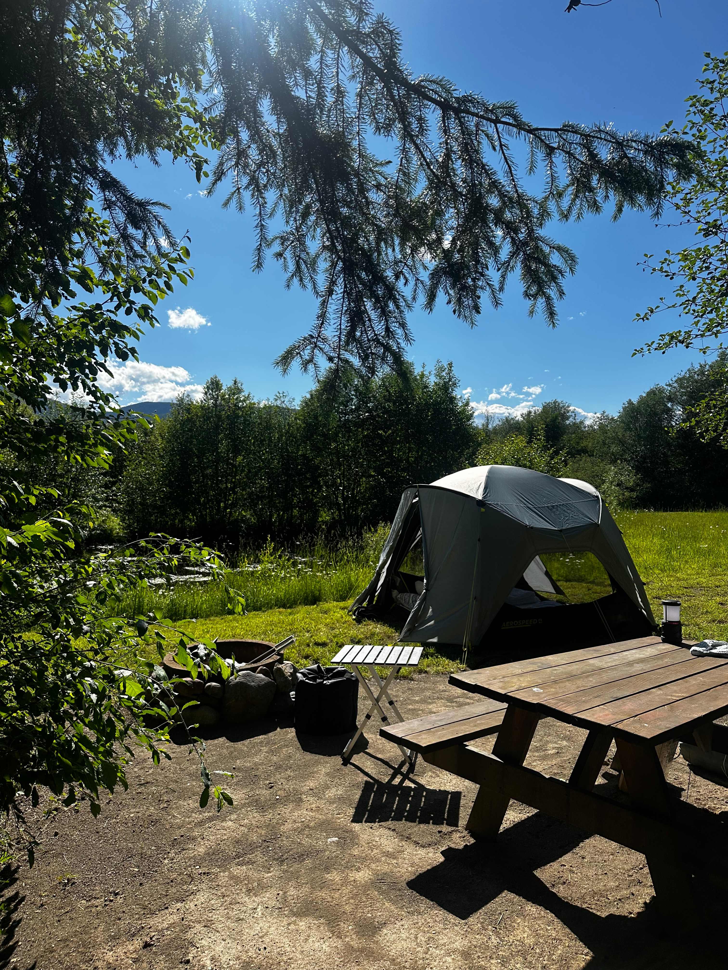 Tent set up near the pond. 