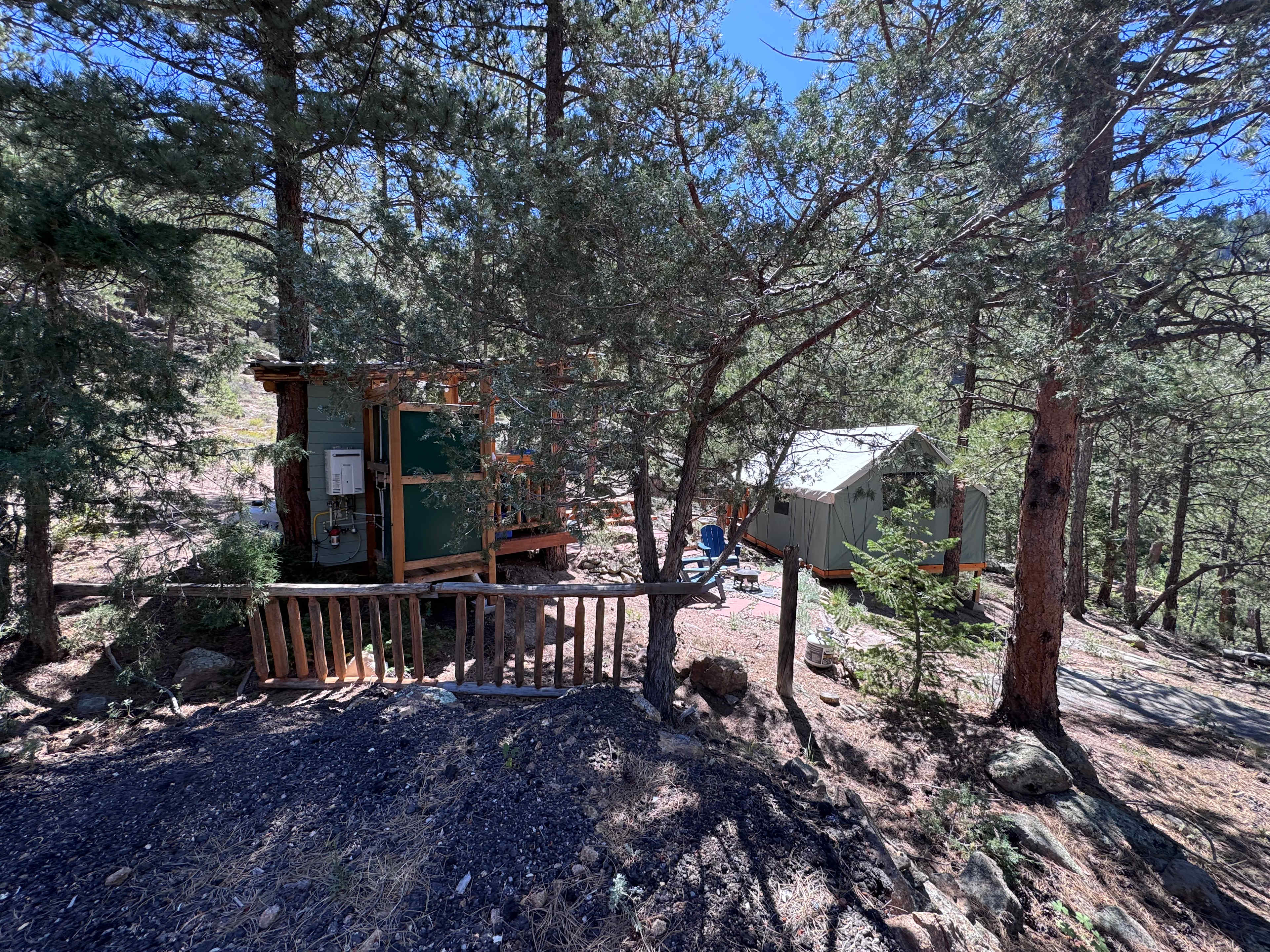 The site from the parking area. The kitchen area is on the left. Fire pit in the middle. Tent sleeping area on the right. 