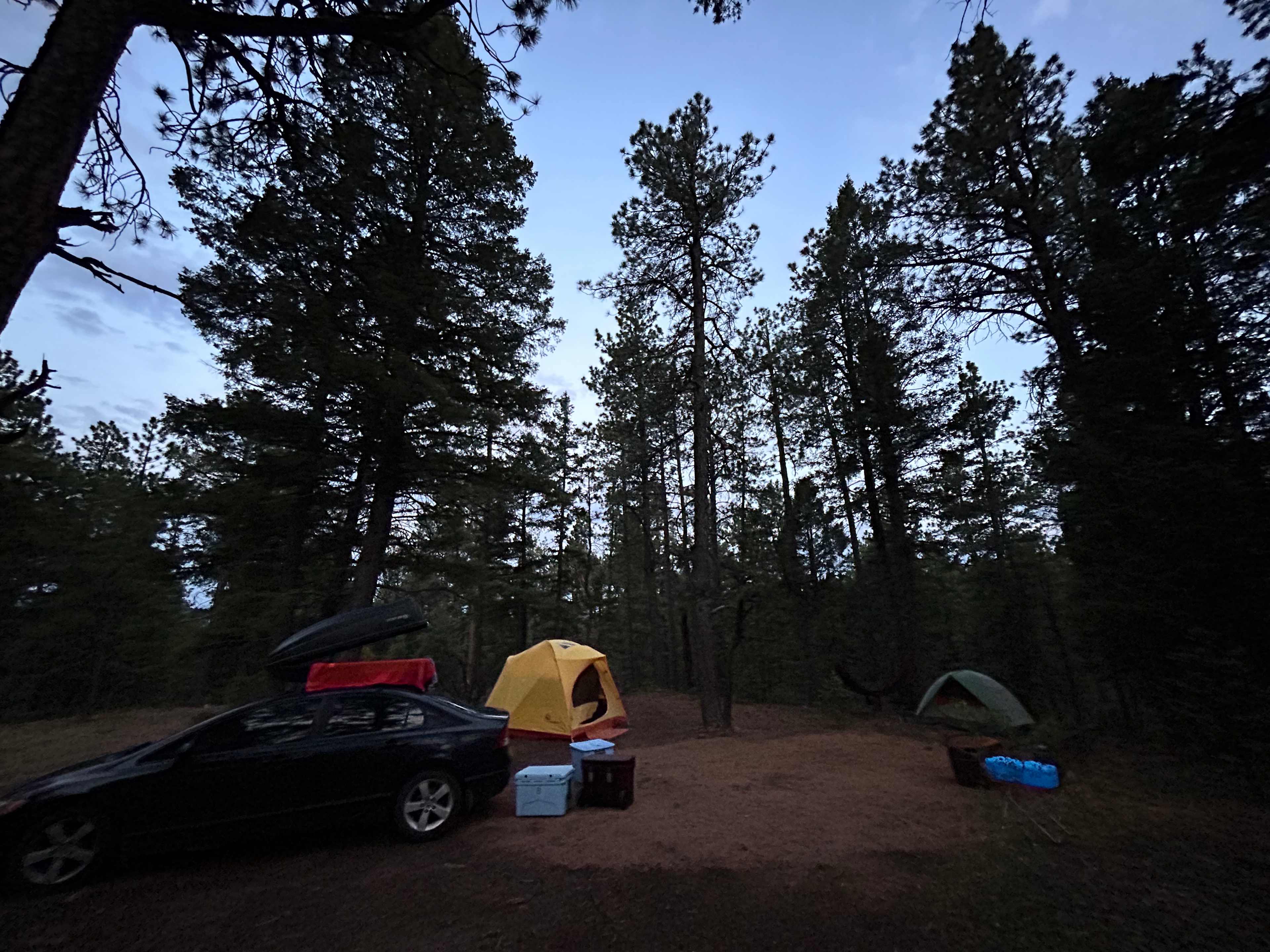 Our site right at dusk — plenty of room for two tents and the car.