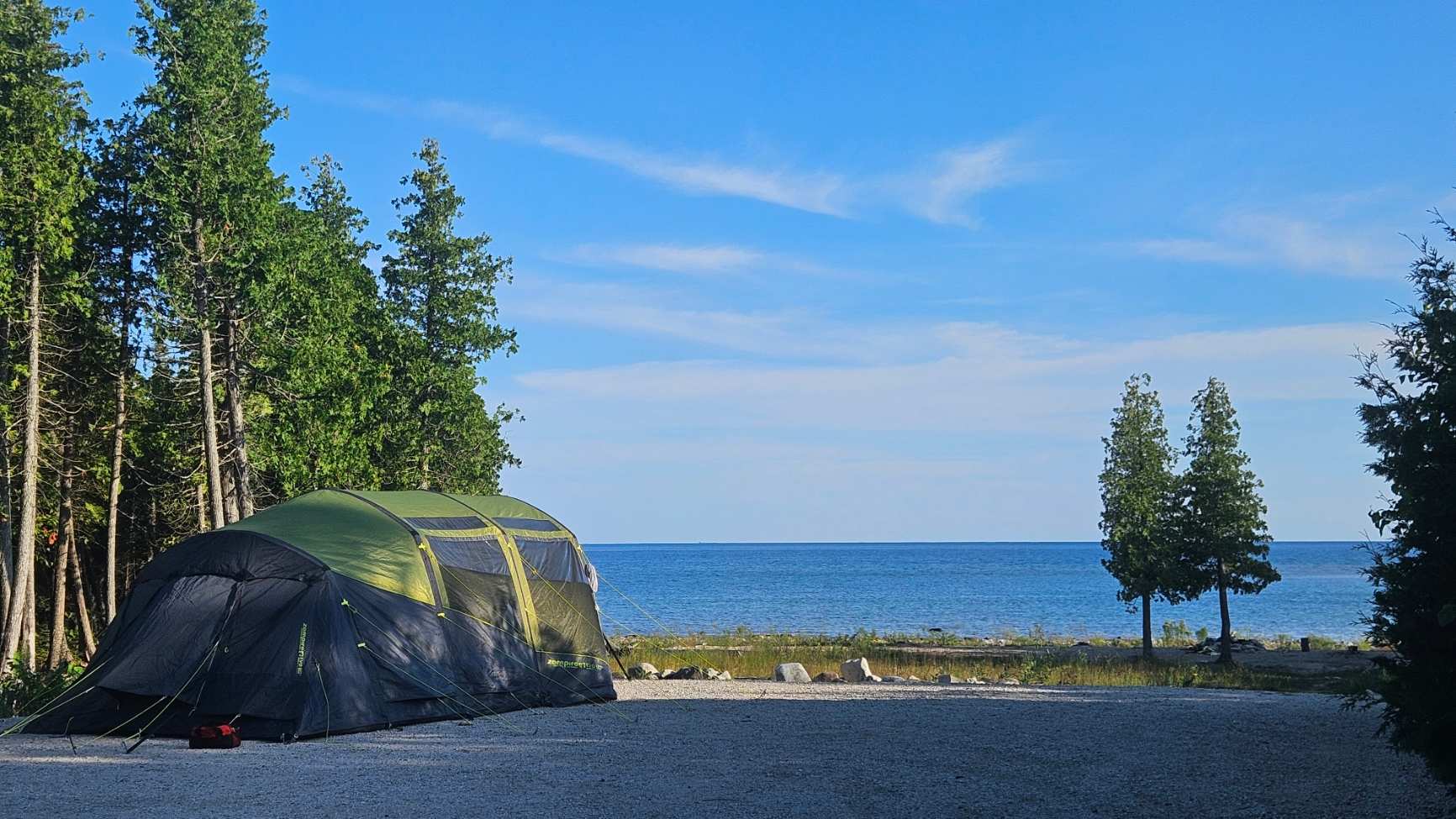 By mid-August the grassy area was more than knee-high so I set up on the pad. Luckily I had big tent spikes and they worked fine. I don't think normal tent pegs would work well FYI.