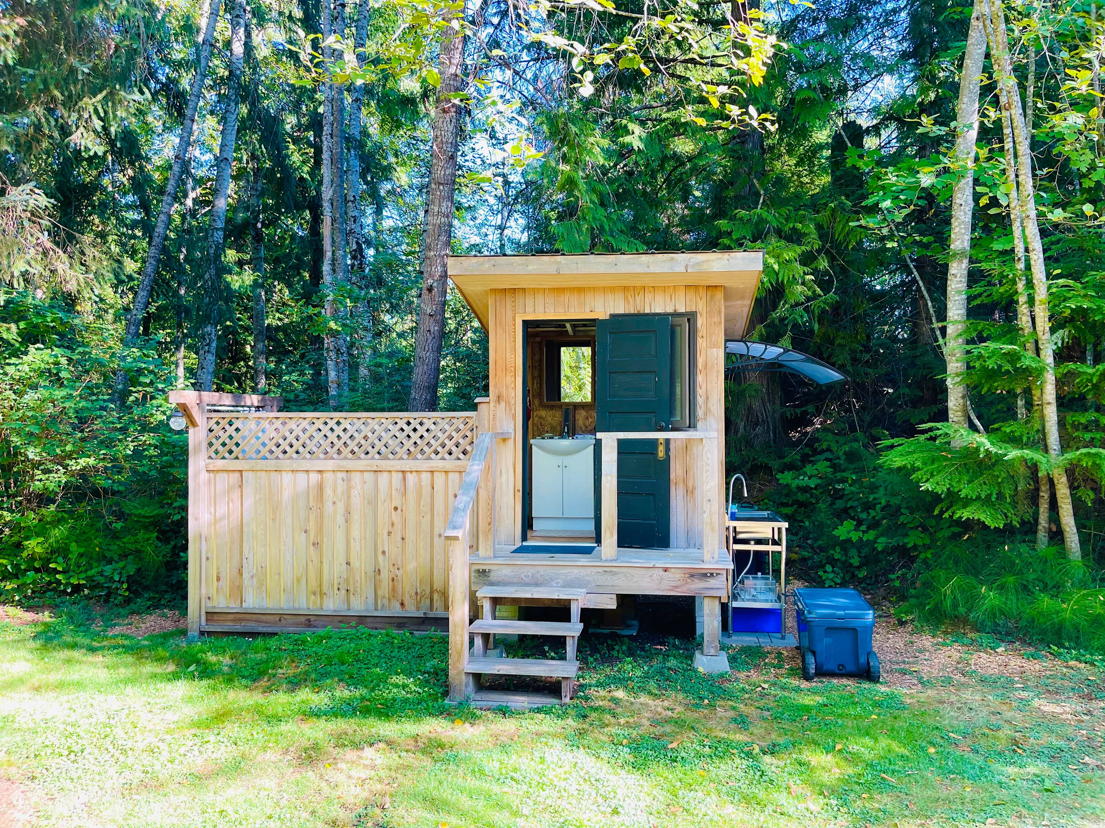 Outdoor shower, flushing toilet and outdoor sink all with hot water. 