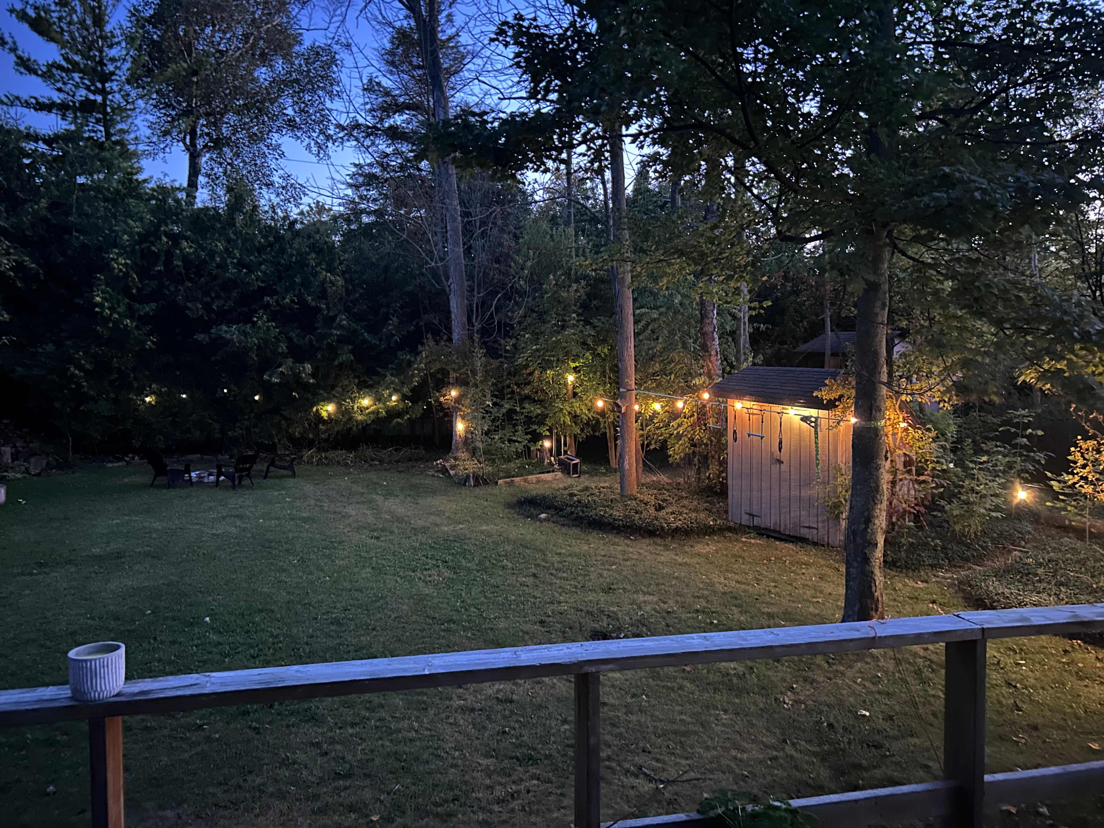 Cozy backyard with deck with bbq and seating  and fire pit. Very private and lit up at night!
