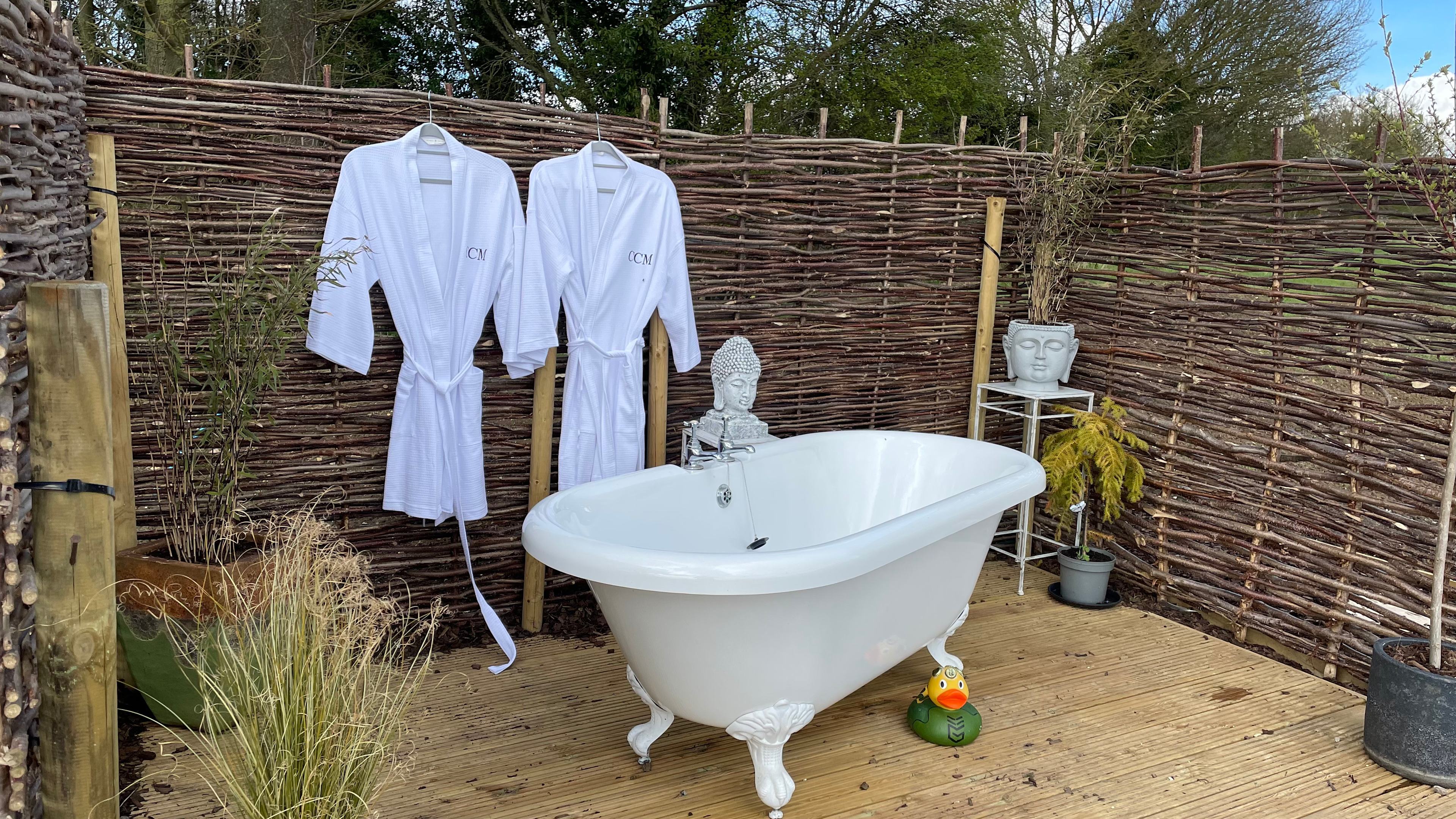 Edward's private outdoor bath set on the edge of a wild flower meadow.