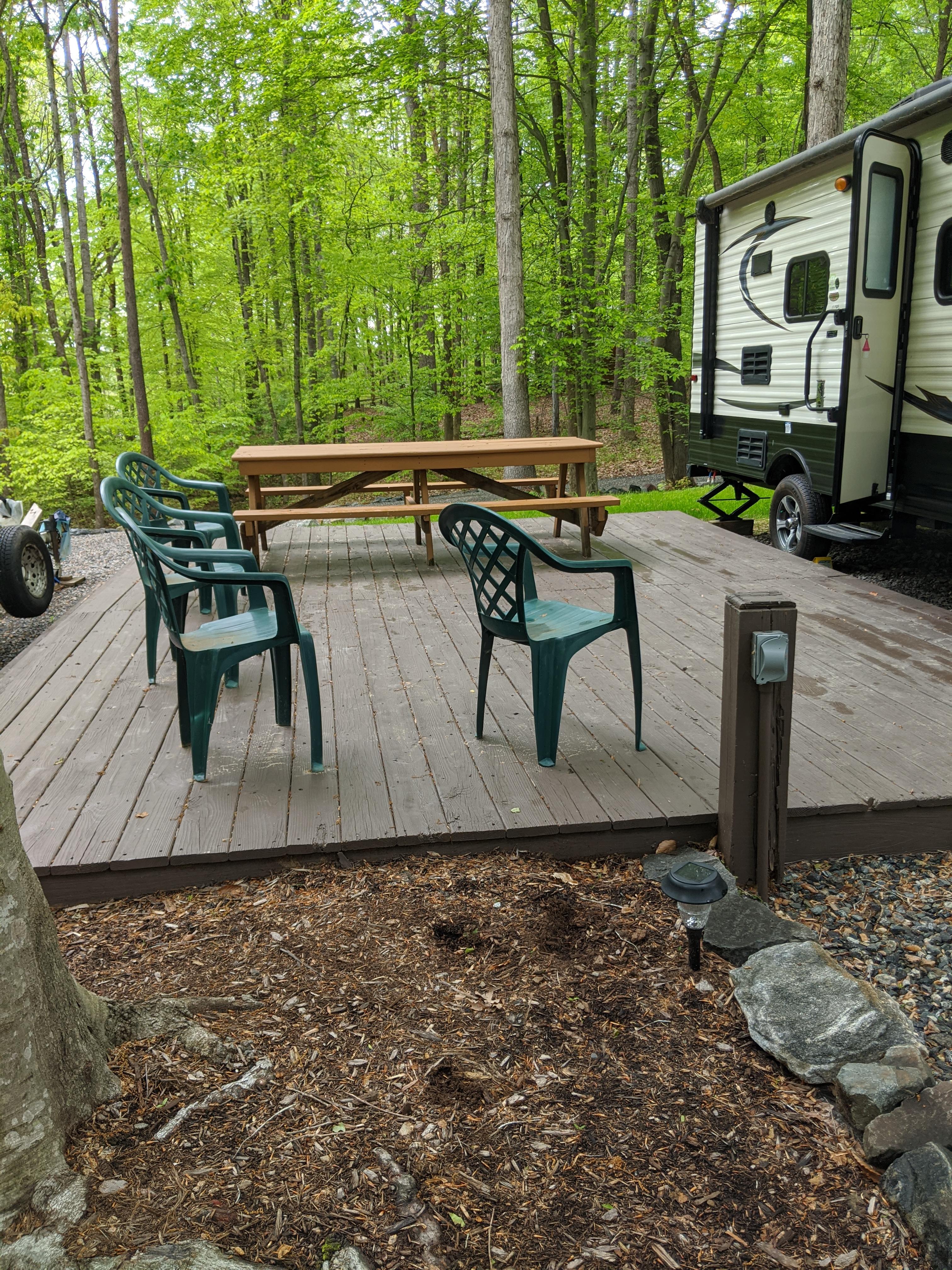 17 Foot Travel trailer parked next to deck