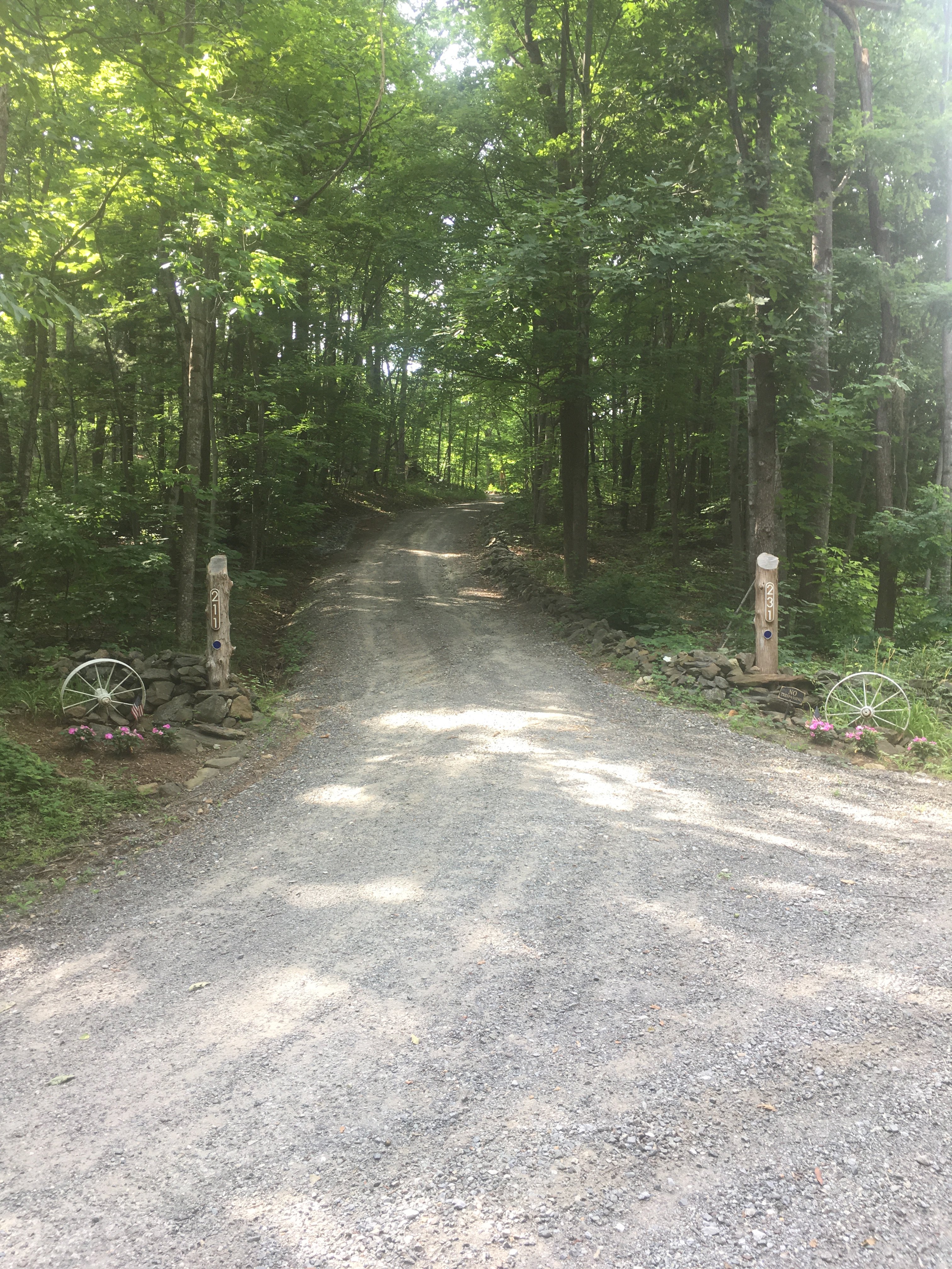 After turning R onto Park Drive, keep an eye out for this sharp L turn at the white wagon wheels. If you miss it, turn around in our upper driveway.  