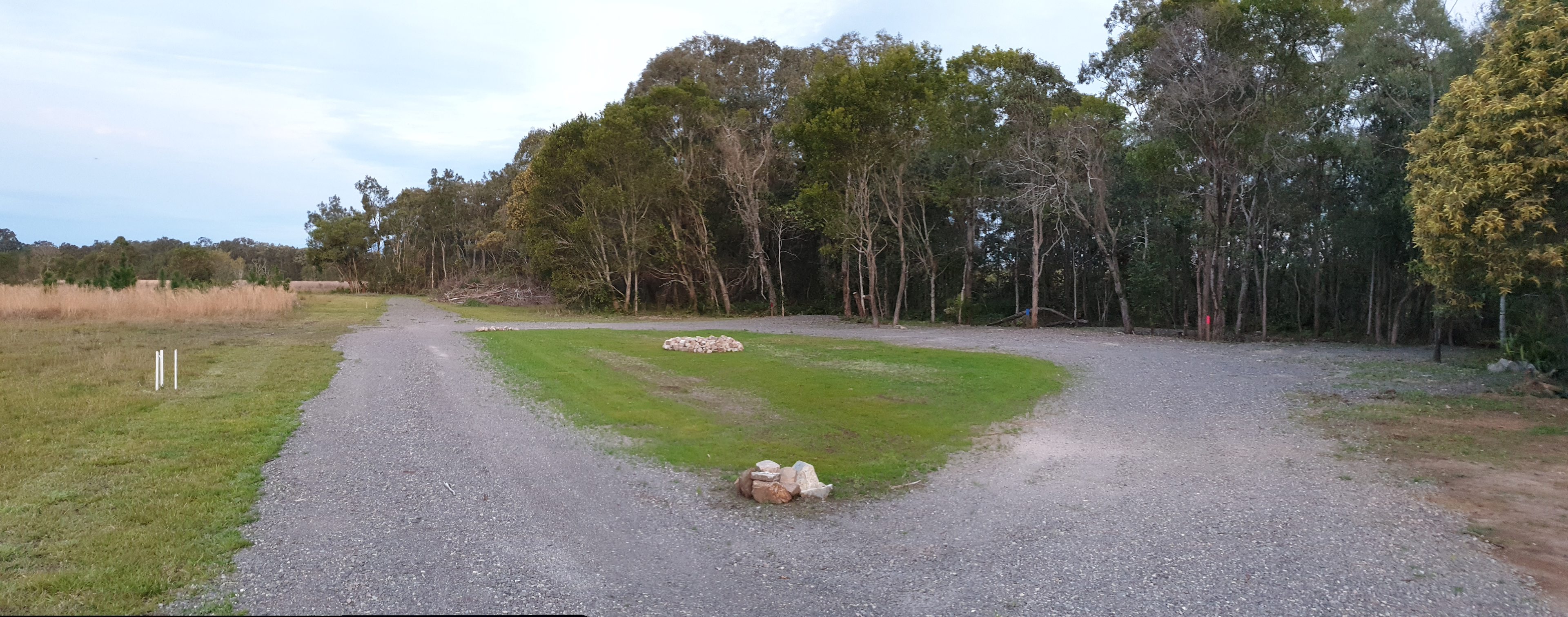 Gravel road in with sites backing into trees