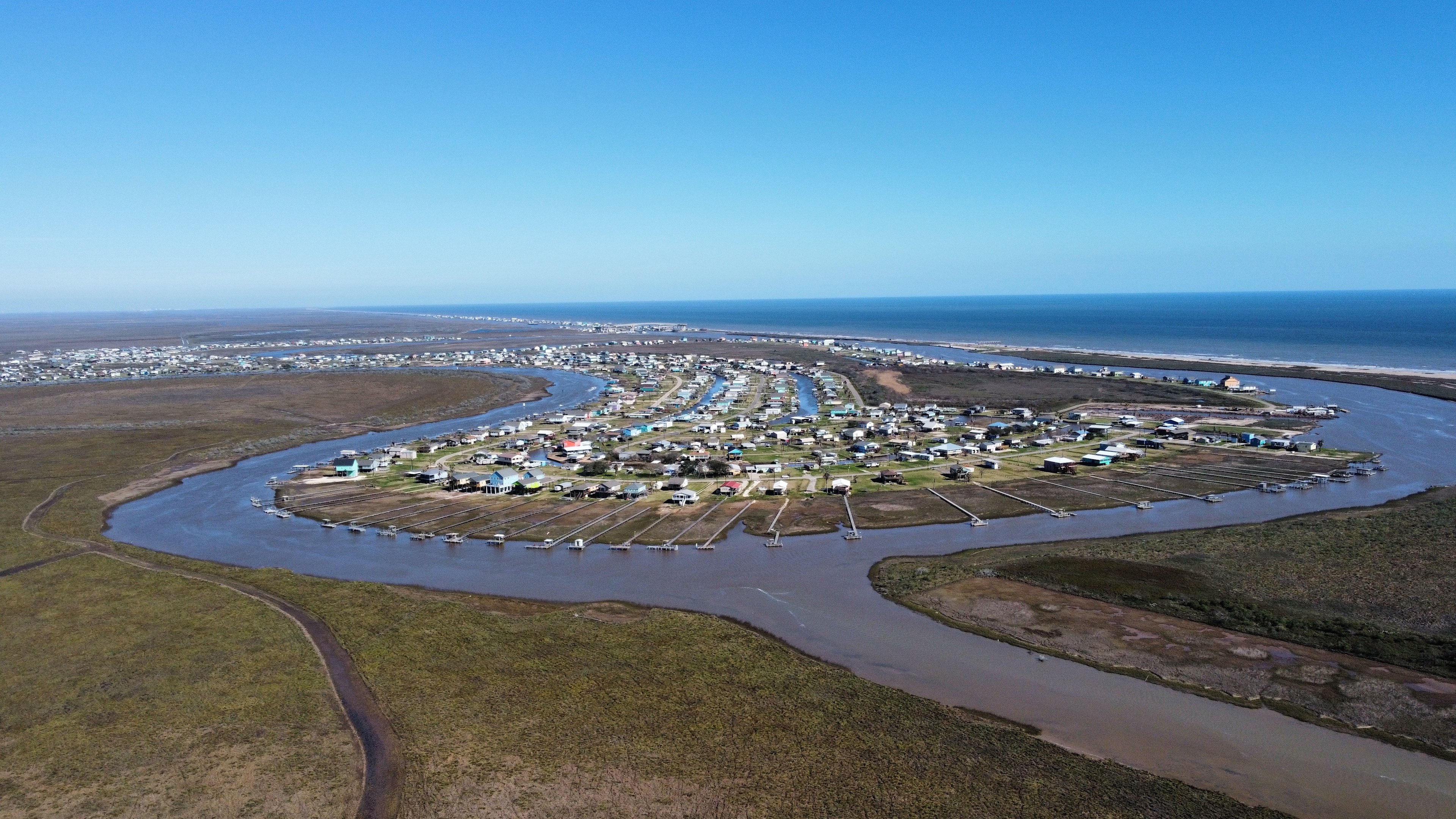 An aerial view from a drone of the neighborhood and the Gulf of Mexico in the background. 