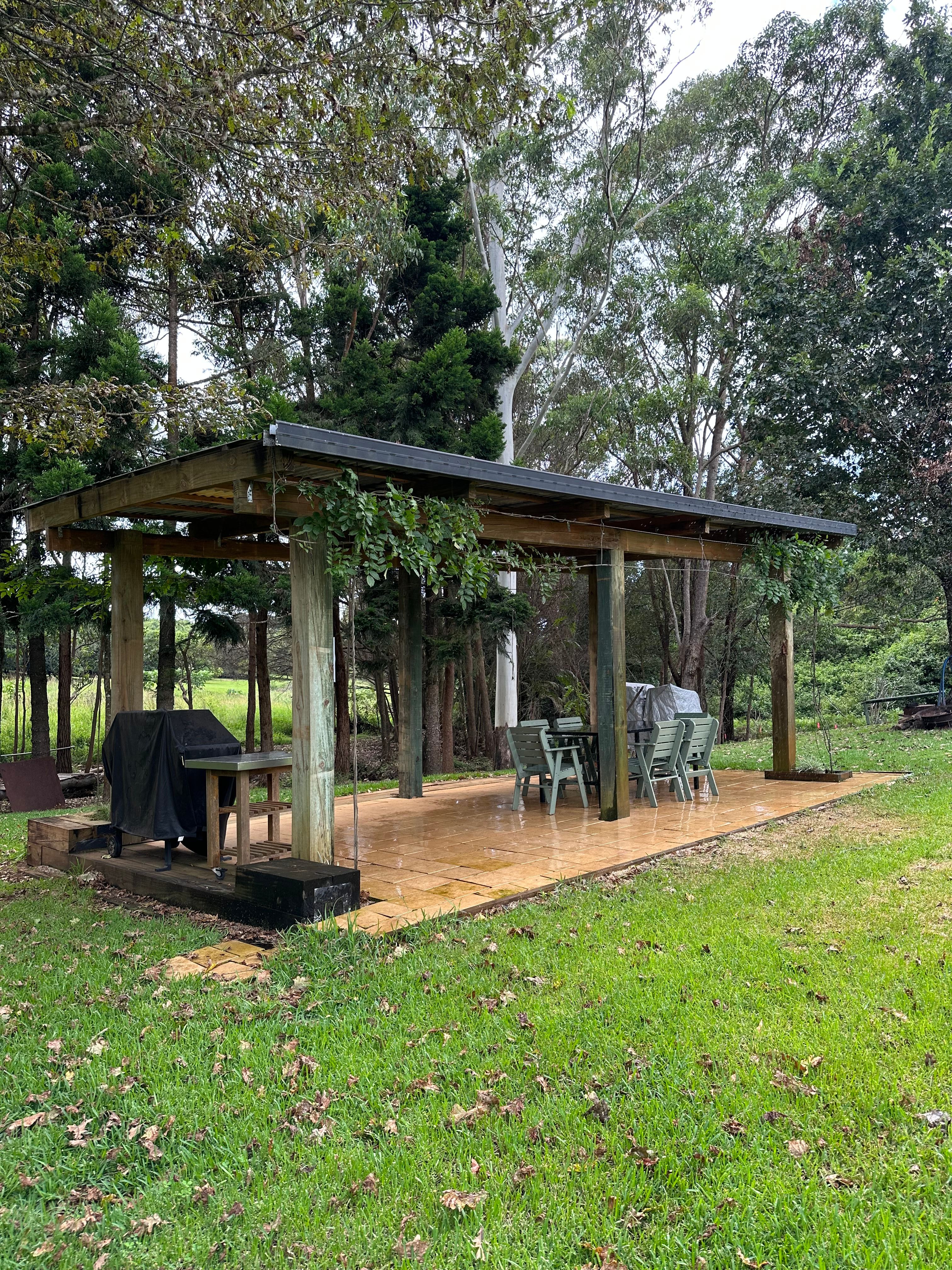 Large covered bbq area with a table and chairs. Also a fire pit for those cold nights.