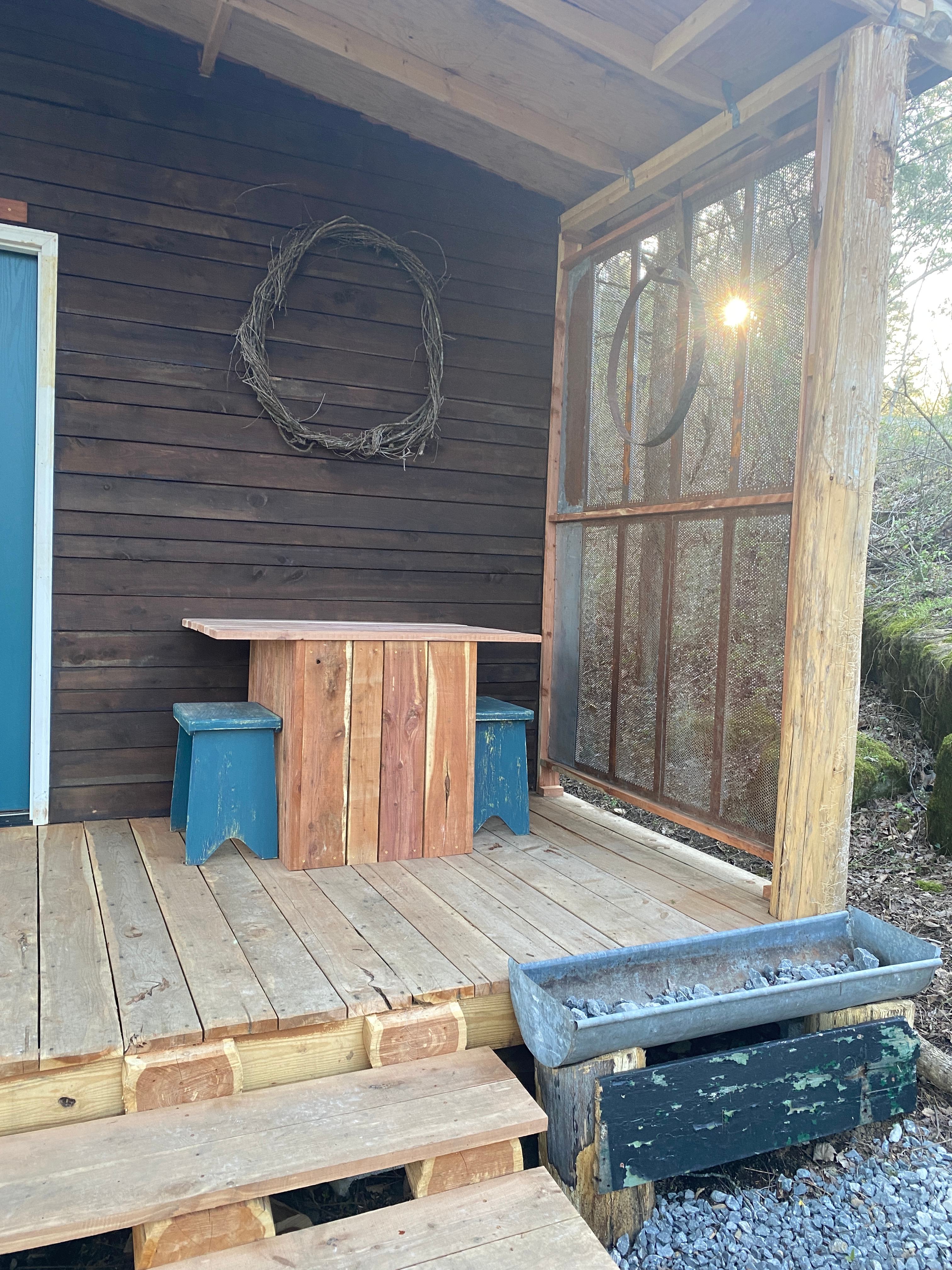 Covered porch and outdoor table and stools at Pecan Ridge Cabin 