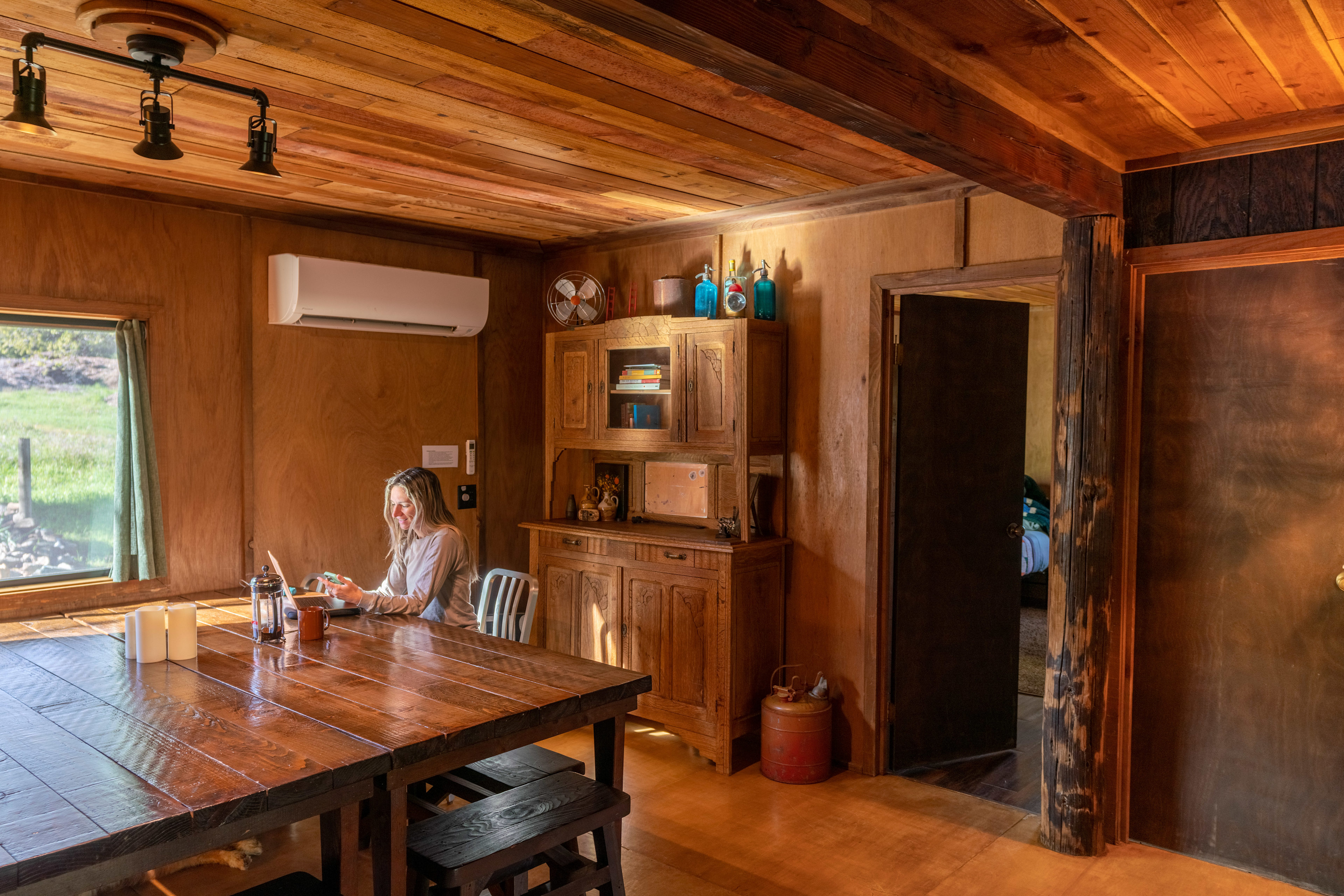 Dining room with a very large table. Plenty of space for large group dinners…or game nights!