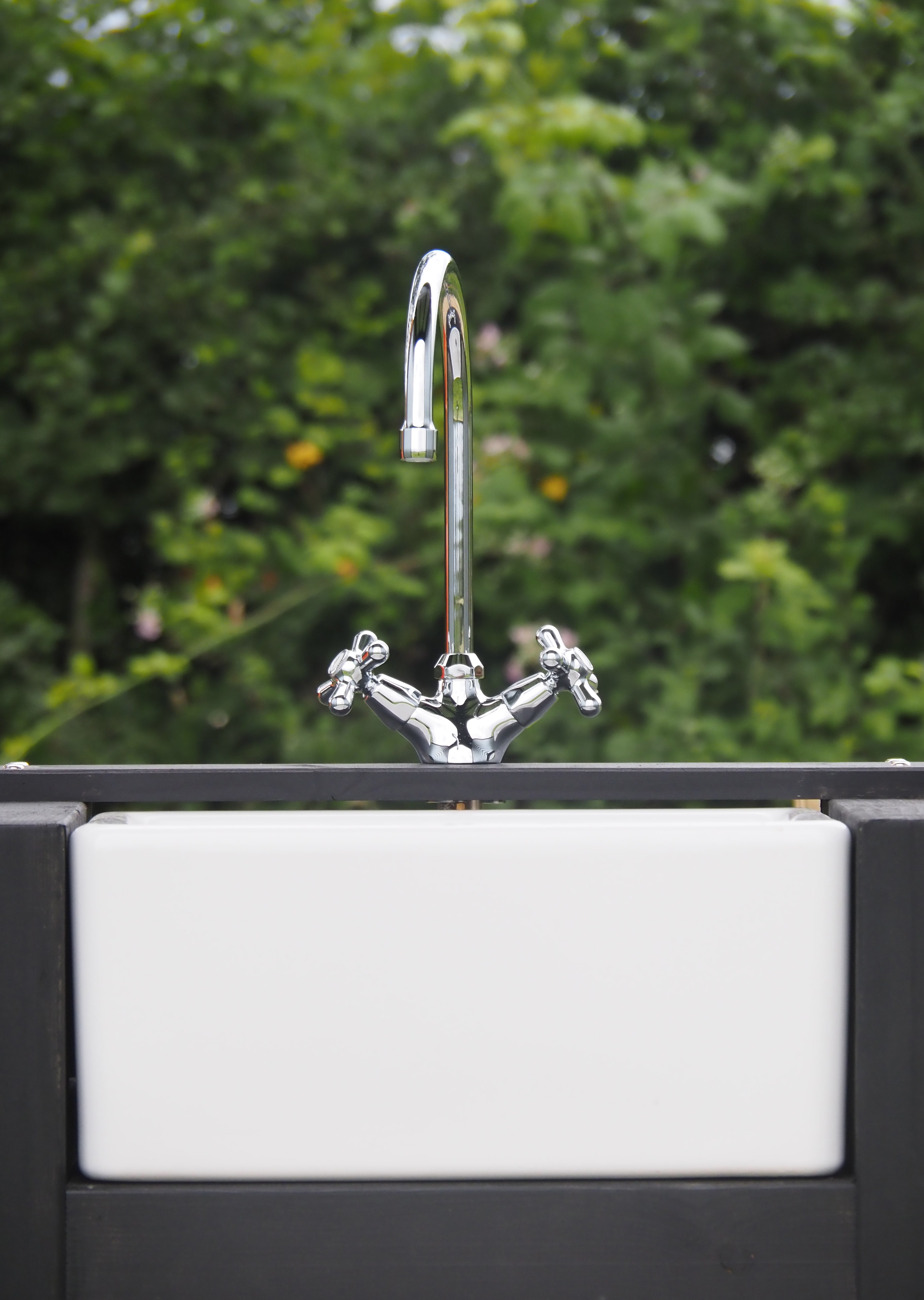 One of our off grid wash houses, providing a hot drench shower, a compost toilet and a beautiful ceramic vanity sink.
