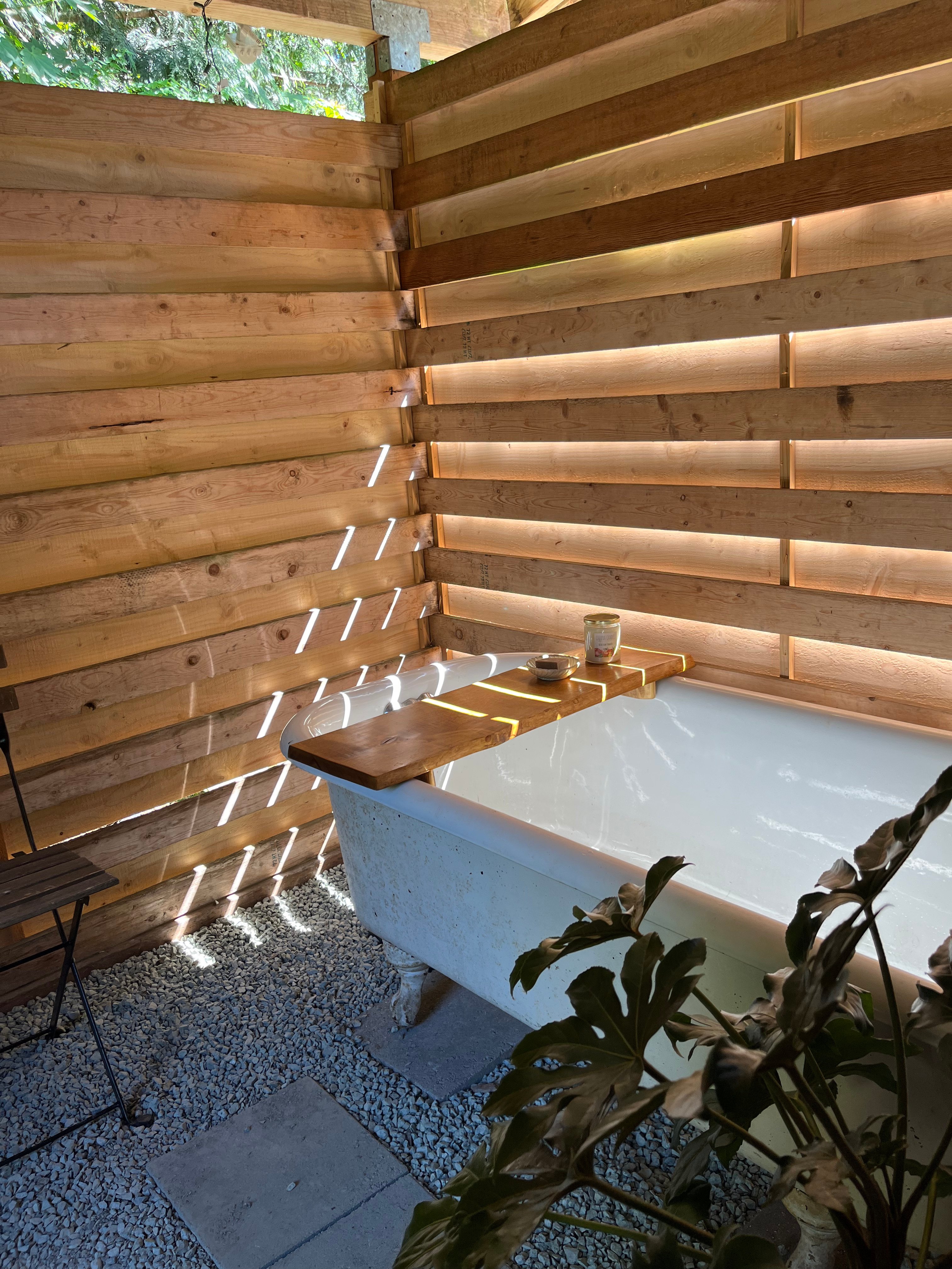 Outdoor tub connected to a solar shower