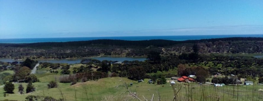 View of property, lake and sea from top of the hill