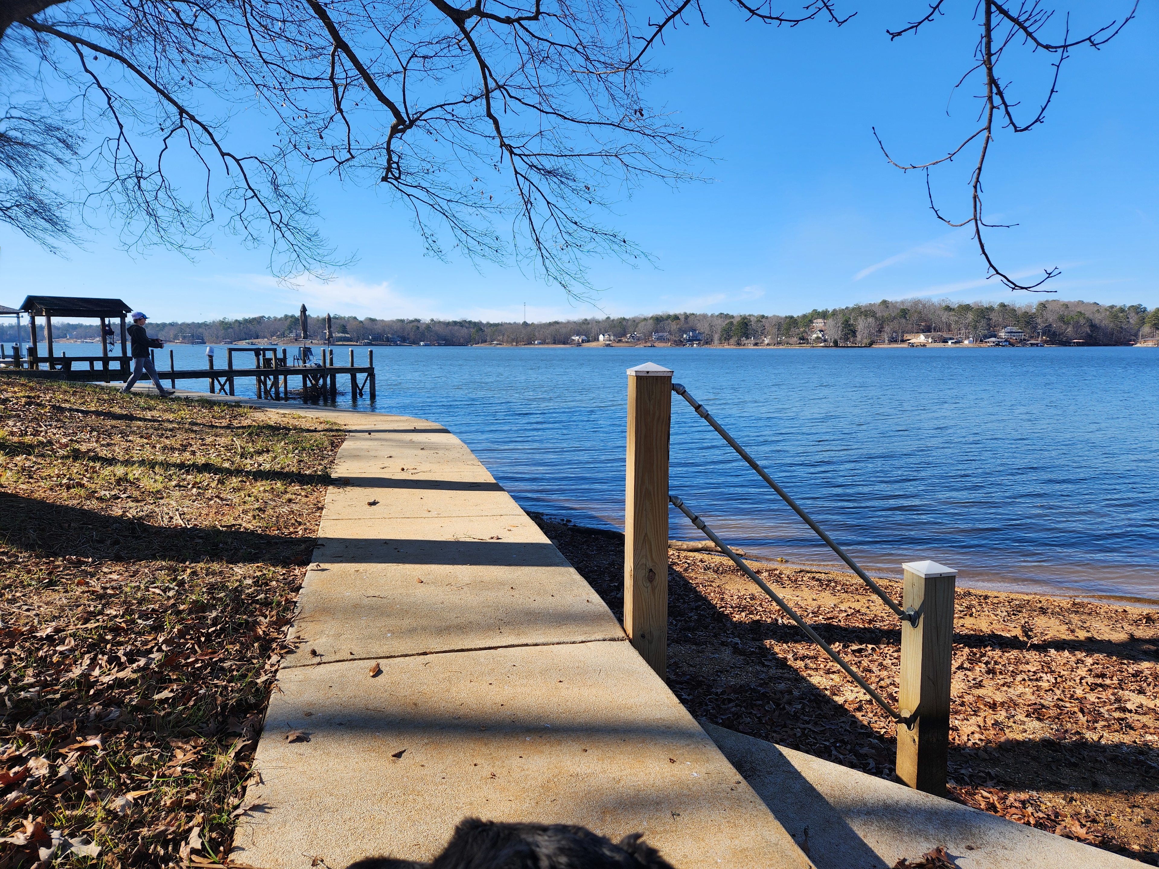 In winter. Sidewalk to left along water.  Other pier in distance. Nice sandy beach