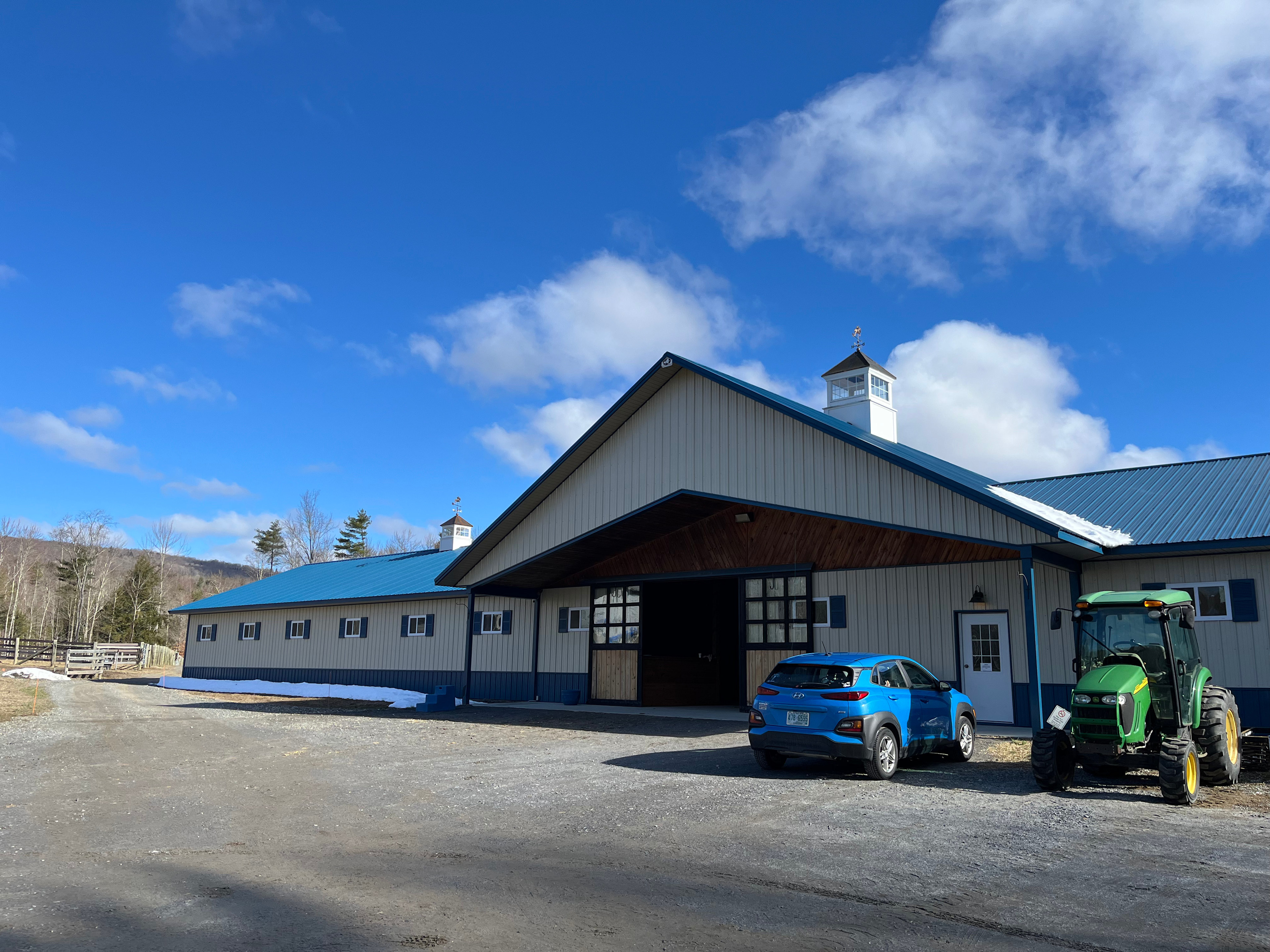Parking lot in front of barn