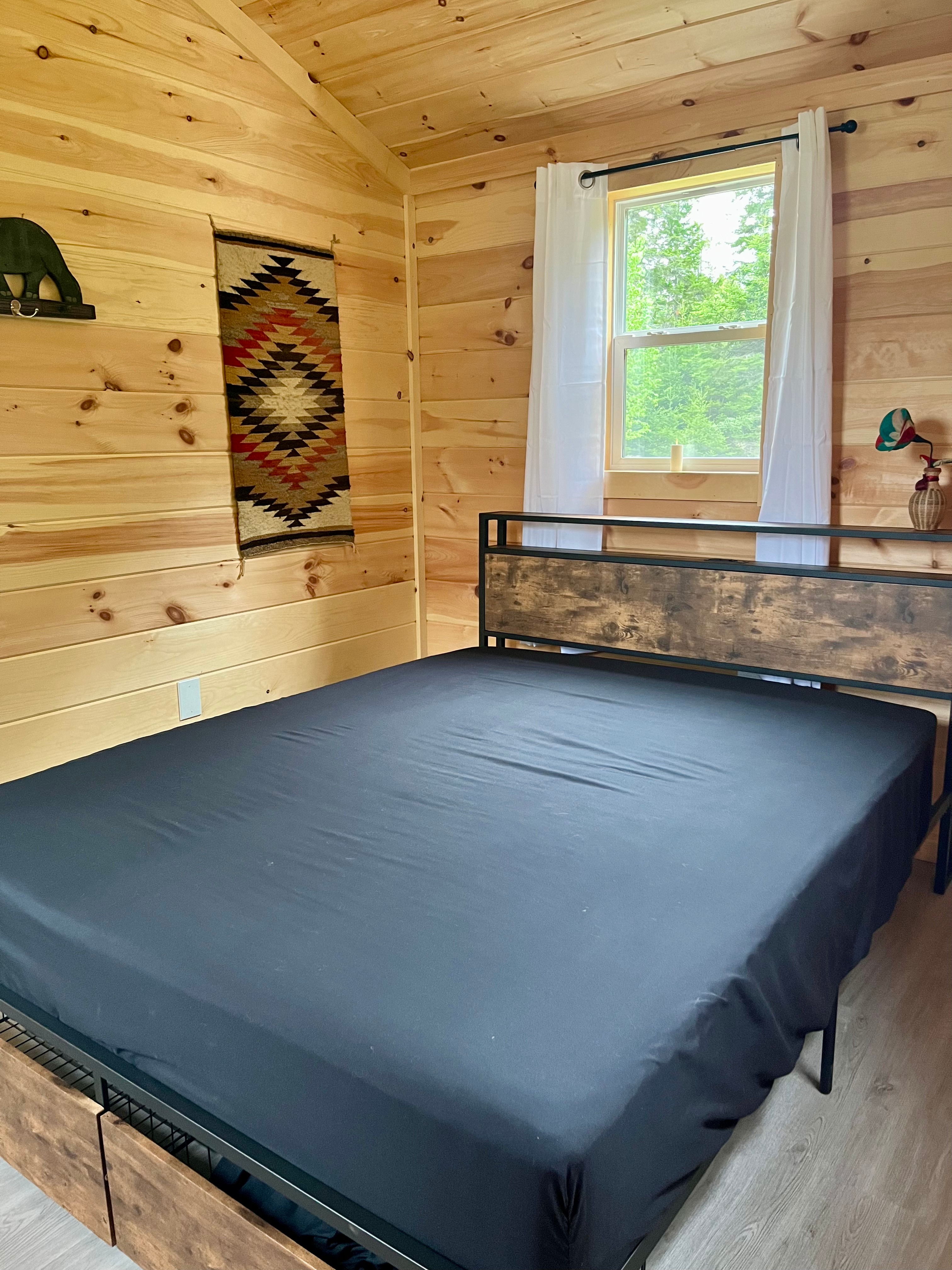Bedroom with queen-sized bed, fitted sheet over mattress pad, and super comfy mattress.
